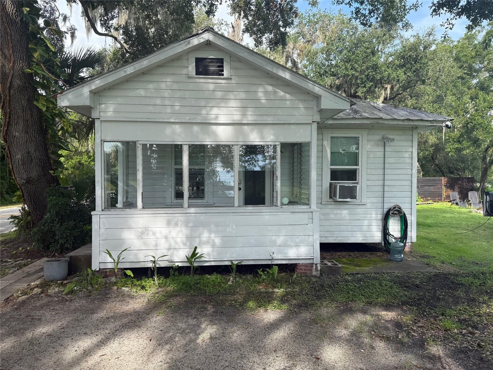 Charming Older Home in New Smyrna Beach. Beautiful mature trees, nice breezes and convenient location. Great layout with 2 bedrooms,1 bathroom with separate entrances and parking on each side. The home has an exterior 240v outlet for Electric vehicle charging. Outside security lights with dusk till dawn bulbs. New windows (2023), new shed (2023), gas tankless hot water heater, public water, and keypad entry are just a few of the upgrades. Great location, just minutes to the beach and the I-95. A great opportunity to own a home in New Smyrna. Call with any questions.
