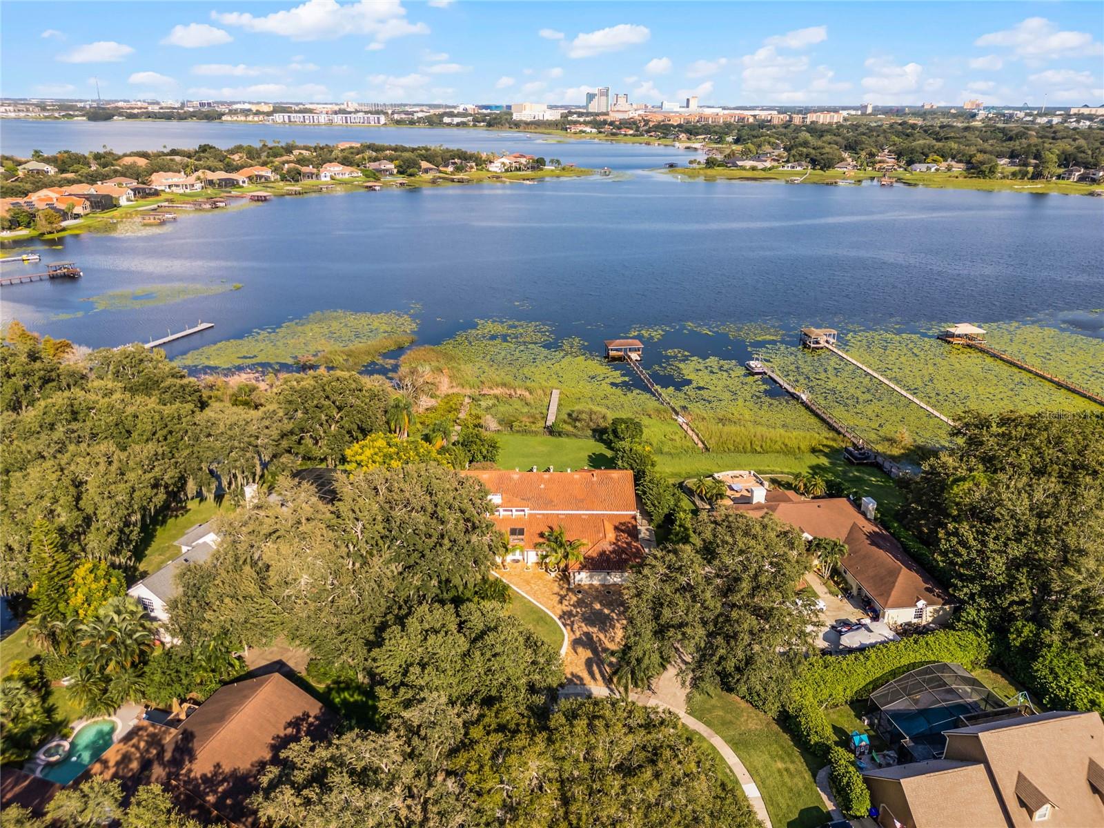 Luxurious Lakefront Estate in Bay Vista Estates, Nested in the coveted Bay Vista Estate community, this stunning 6-bedroom, 7-bathroom lakefront home offers unparalleled luxury living. Perched on the shores of Big Sand Lake, this magnificent residence boasts breathtaking panoramic views from its expansive windows, seamlessly integrating indoor and outdoor living spaces. Interior Features; Soaring high ceilings and abundant natural light, Tile flooring throughout, custom-designed kitchen with double refrigerator, stainless steel appliances, middle island, and oversized nook area. This beauty offers a flexible and accommodating floor plan, every room is an en-suite, the elegant stairs with iron railing take you upstairs to a spacious and additional family room and office with a lake view, and to the luxurious master suite that is breathtaking and a second bedroom with private bath. Step outside to your private oasis featuring a sparkling pool, and expansive paved area with a fully equipped outdoor kitchen perfect for hosting unforgettable gatherings with beautiful Florida weather! The home location is in a top A-rated school district, near restaurant row, upscale shopping, and dining, and convenient access to the airport and theme parks. Experience the best of Orlando's luxury lakefront living. Schedule Your Private Tour Today!
Don't miss this rare opportunity to own a one-of-a-kind lakefront estate in Dr. Philips. Contact me to arrange a private viewing and make this incredible property yours.