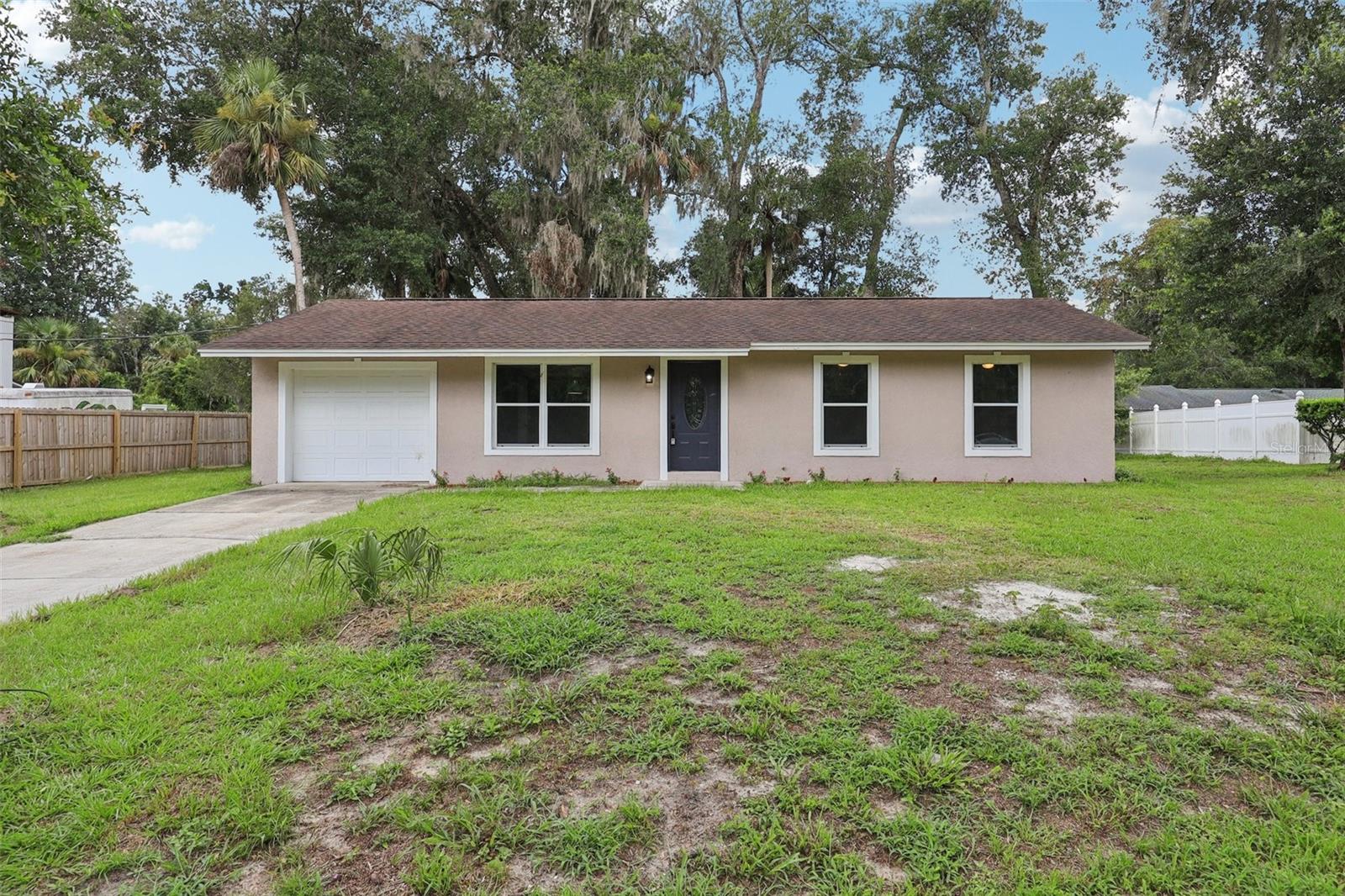 One or more photo(s) has been virtually staged. Totally Renovated Block Stucco Home in the Heart of DeLeon Springs!
This beautifully updated 3-bedroom, 1.5-bath home sits on a spacious 110x100 lot and is completely move-in ready. The gourmet kitchen is a showstopper, featuring a stunning all new stainless steel appliances to include a ceramic tile cooktop, built in oven and microwave, and hood, quartz countertop, gold accent fixtures, subway tile backsplash with gold accent grout, soft-close cabinetry with gold handles, breakfast bar and elegant crown molding throughout.
You'll love the bright and open layout with freshly painted interior and exterior, knockdown ceilings, newer windows installed in 2023, brand-new ceiling fans, newer carpet in the bedrooms, gorgeous 15x30 ceramic tile panels in the kitchen, living/dining room and baths, updated doors and hardware. The bathrooms have been tastefully remodeled with modern finishes and gold accents.
The roof was replaced in 2017, the HVAC system 2012 and maintained and the hot water heater 2024. The electrical panel has been updated, the well pump is also new in 2024, and the septic system was pumped in 2023. A one-car garage provides secure parking and additional storage.
Located just 5 minutes from beautiful DeLeon Springs State Park, 20 minutes to the beaches, and 30 minutes to Orlando, this turnkey property is perfect for first-time homebuyers or those looking to downsize. This home is turn-key!!! Call today before this Home says "SOLD"