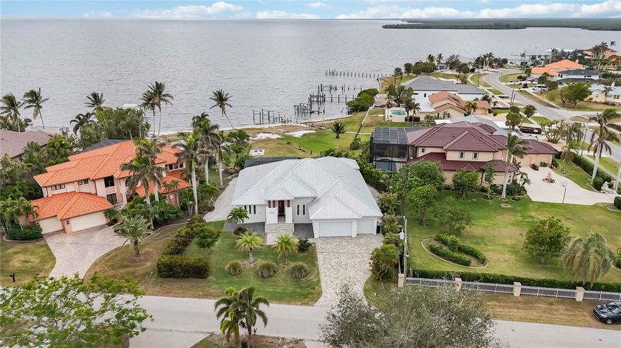 PRICE REDUCED!! FULLY FURNISHED WITH TOP END FURNISHINGS! Only personal items will not convey- Seller relocating to Tampa.
The breathtaking water views serve as a serene backdrop to this exquisite 4-bedroom, 3-bathroom waterfront, gulf access sanctuary with breathtaking, unobstructed views of Charlotte Harbor from nearly every room. This custom-built home built in 2020 offers both construction features and an elevation that were designed to prevent damage from storms. The home is built above flood level, has over-engineered construction foundation and roofing features, Engineered and Built WELL above flood requirements , keeping water out and insurance LOW!
 
No Expenses have been spared in the Well Appointed Waterfront Pool Home featuring Standing Seam Metal Roof, Impact Glass Windows, Aluminum Soffits with 2 ft. overhang for Maximum Sun Protection, Four (4) Bedrooms, Three Full (3) Baths, Attached Oversized Three (3) Car Garage, Travertine Flooring throughout, Solid Wood Cabinetry throughout, Solid Core Interior Doors throughout, Spray Foam Insulation, Volume Ceilings, Open and Bright Great Room with Floor to Ceiling Entertainment Wall with 74"Dimplex Electric Fireplace, 75" LG TV and Bose Soundtouch Soundbar, Zero Corner Doors, Open Kitchen with Expansive Island with Breakfast Bar, GE Profile Appliances, Built in Oven, Induction Cooktop, Stone Counters, Luxurious Private Owners Suite, Separate Den/Piano Room or would make a Great Executive Home Office, Large Laundry Room with Additional Storage. Plantation shutters throughout add a touch of timeless elegance while offering privacy and natural light. Ideal for Entertaining is the Additional Living Space provided by the Spacious Lanai with a newly installed retractable Hurricane Shutter offering additional protection from storms or indoor/outdoor living options, Pre-plumbed Outdoor Designated Kitchen Area with Vent in Place ready for you to Customize your Outdoor Grilling Needs and the Screened Saltwater Pool with new pool heater. Paver Drive and Walkway, there is room on the Eastside of the Home to Park an RV and on the Right side of the Home there is a Custom Rack to Store Kayaks/Canoes. Electrical panel set up for Portable Generator (included with sale). There is a large .5 acre yard and your own Private Sandy Beach, giving you Endless Views and Spectacular Sunsets, plus you are moments to Outstanding Boating, Fishing, and Kayaking. You will be just a Short Drive to the Port Charlotte Beach Complex, Tennis, Shopping, Airports, the Sunseeker Resort, Rays Sports Complex, Dining, Medical, Punta Gorda, Boca Grande, Golf, Pickleball and all that Southwest Florida Offers.
 
Seller has dock plans approved by the Corps of Engineers and quote for future dock available. Seller to include one year home warranty with purchase. We Invite you to schedule a Tour and Make an Offer Today, your Waterfront Lifestyle awaits. Current Homeowners insurance yearly policy is $3250 and Flood Policy yearly is $1847.