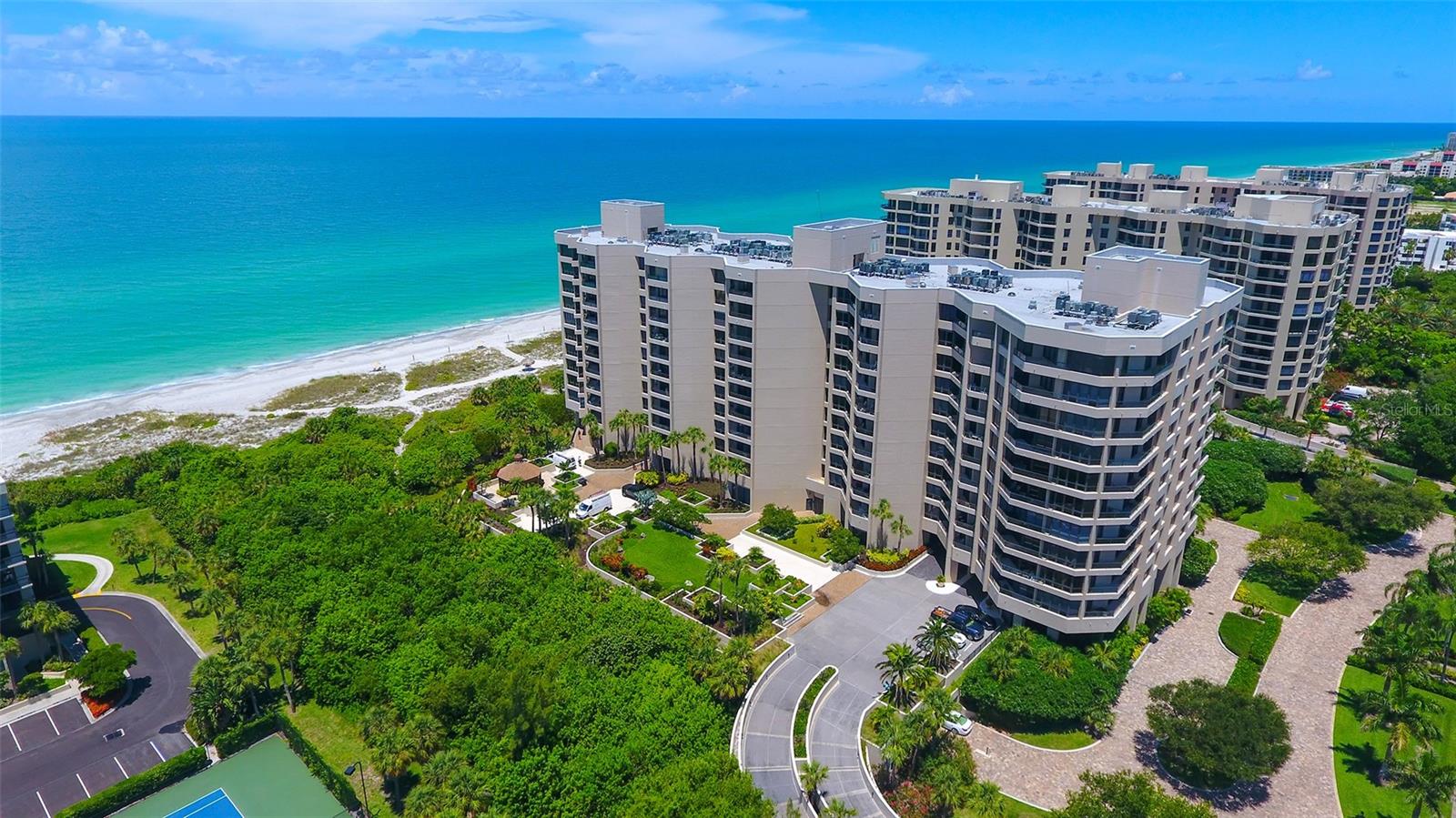 Exceptional opportunity to own this beautiful first-floor condominium at The Promenade, offering the perfect balance of comfort, and coastal charm with nearly 400 feet of private beach frontage and partial views of the Gulf of Mexico from almost every room.
This spacious two-bedroom, two-bathroom split floor plan features a bright, open layout ideal for entertaining or relaxed living. The kitchen flows seamlessly into the expansive living and dining areas, creating a connected and inviting space. Enjoy stunning northwest sunset views from the comfort of the great room or step outside to the private balcony for a peaceful retreat overlooking the Gulf.
The elegant primary suite offers balcony access, a large walk-in closet, and a spa-like en-suite bath with a soaking tub and walk-in shower. The generously sized guest bedroom is perfect for visitors or can be easily adapted as a home office or hobby room.
The Promenade offers a true resort-style experience with a 24-hour staffed gatehouse, full concierge services, and secure under-building assigned parking. Residents enjoy a heated Gulf-front pool and spa, a spacious sundeck with shaded gazebo and grilling area, four Har-Tru tennis courts, a well-equipped fitness center, a craft room, and inviting social spaces. Private beach access lined with charming tiki huts completes the picture of effortless coastal living.
Don’t miss this rare opportunity to embrace the ultimate Longboat Key lifestyle, where every day feels like a vacation