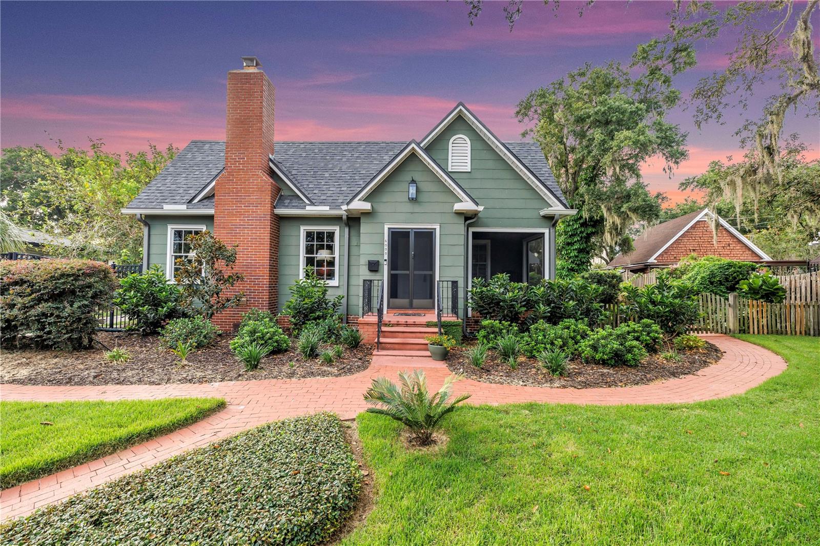 Welcome to 6009 Roberta Circle—a charming and meticulously updated two-story bungalow nestled on the shores of Lake Roberta in the highly sought-after historic Hampton Terrace neighborhood. Bursting with character, this light-filled home welcomes you with a brick-paved walkway and a freshly screened front porch, setting the tone for the warmth and detail found inside. Original walnut-stained hardwood floors, a cozy wood-burning fireplace, and custom built-ins reflect the home’s timeless charm, while thoughtful updates bring modern comfort and style. Since purchasing, the owner has added a new roof on both the house and garage, new gutters, a new sewer line, a complete irrigation system and Zoysia sod in the front yard, and landscape lighting with lush plantings including a Sylvester Palm. The spacious deck and firepit area have been re-stained and create an ideal outdoor retreat, with room to add a pool for your dream backyard oasis. Inside, updates include a refreshed kitchen with a new custom coffee station, renovated bathrooms with a new vanity in the primary suite, new light fixtures and ceiling fans throughout, fresh interior paint, new window treatments, crown molding in the living and dining rooms, and added outlets for TV mounts in both the living and primary bedrooms. The screened porch has a brand-new frame and screening, and the fencing has been repaired and replaced where needed. For peace of mind, a Simply Safe alarm system has been installed, and the home has been recently tented for drywood termites, complete with an extended warranty covering both drywood and subterranean treatment. The oversized lot includes a two-car garage that offers the potential for conversion to guest quarters or an income-producing rental. Situated just minutes from popular local eateries, parks, and the Tampa Riverwalk, this home offers the perfect blend of historic charm and modern convenience in one of Tampa’s most beloved neighborhoods. Whether you're enjoying peaceful sunsets over the lake or entertaining on the back deck, 6009 Roberta Circle is more than a home—it's a lifestyle. Schedule your private showing today!