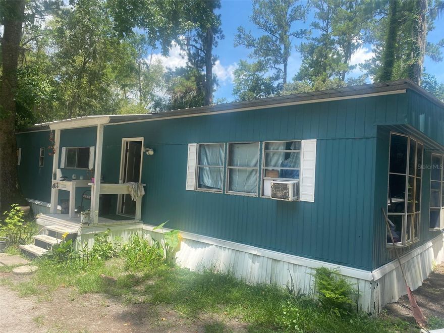 Great starter home close to Historic Melrose . **POSSIBLE OWNER FINANCING** . This large 3/2 home is on a Santa Fe Lake Canal with access to lake. Home sits on a corner lot with lots of privacy. There is a creek that flows next to the home and a charming little bridge that connects the roads. The home has been upgraded from its original, larger kitchen, open floor plan, large master bedroom with nursery, metal roof and back addition. Home is only 15 minutes to Gainesville and just a few miles form Santa Fe Park,with a full outdoor workout center, 2 cookout pavilions and 2 boat ramps to launch into 6000 acre Lake Santa fe, Melrose Bay Park, and Downtown Melrose for plenty of live music , art walks, farmers markets  and food trucks. Come experience the small towns in our area and the ' Lake Life "
***FINANCING TERMS: 20% DOWN, 3 YEAR BALLOON, PAYMENTS WILL BE AMORTIZED FOR 15 YEARS  5%.**
Central A/C works just needs new ductwork.