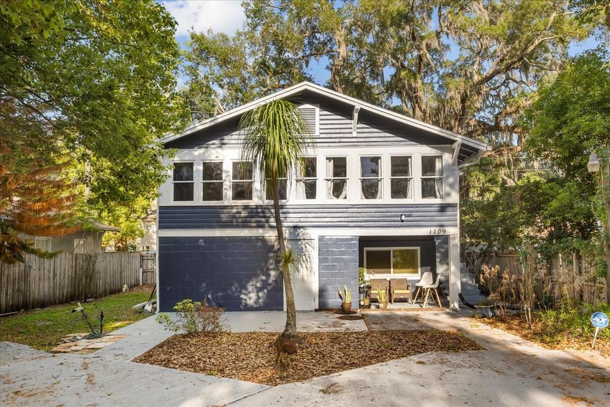 Nestled in an established Sanford neighborhood, 1209 Myrtle Avenue is surrounded by mature trees and lush greenery, offering a private and shaded setting that stands out from typical properties in the area. The aerial perspective highlights the home’s generous lot size and prime positioning, with convenient access to nearby roadways, local businesses, and everyday amenities. The exterior presents a distinctive two-story elevation with a spacious driveway and covered lower-level entry, creating both functionality and curb appeal, while the natural canopy enhances the peaceful residential atmosphere.
Inside, the home features a bright and inviting living area highlighted by expansive windows that fill the space with natural light and provide serene views of the surrounding greenery. The open layout flows seamlessly into the kitchen, creating an ideal environment for both everyday living and entertaining. The kitchen is designed with functionality and efficiency in mind, offering ample cabinetry, generous counter space, and a practical layout, complemented by natural light and clean finishes. An additional secondary kitchen area provides flexibility for extended use, multi-generational living, or added utility, enhancing the overall versatility of the home.
The bedrooms are comfortable and well-sized, offering flexible layouts suitable for a variety of living arrangements, including guest rooms or home office setups. Natural light and neutral finishes create bright, livable spaces, while the primary bedroom stands out with its spacious configuration and added room for seating or storage. The bathrooms are thoughtfully arranged with clean finishes and practical design, featuring a tiled shower surround, updated vanity, and well-lit layout that supports ease of maintenance and everyday use.
A dedicated laundry and utility area adds to the home’s functionality, providing convenient washer and dryer space along with additional room for storage and organization. Throughout the property, the combination of efficient layouts, livable spaces, and a desirable location creates strong appeal for both owner-occupants and investors alike.
With its spacious lot, private setting, and proximity to key amenities, this property presents an excellent opportunity for those seeking comfort, flexibility, and long-term potential in a growing Sanford market.