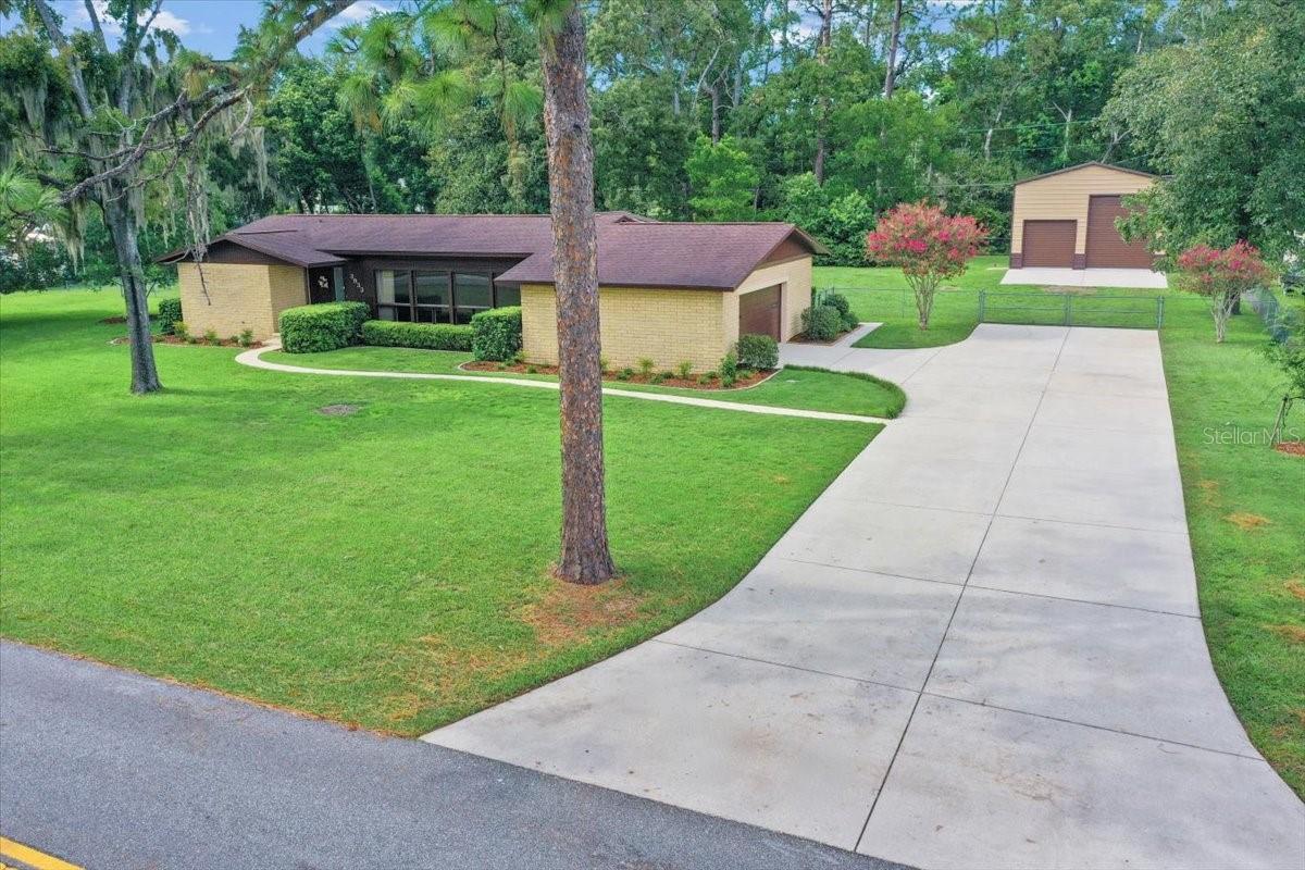 CUSTOM MID-CENTURY GEM IN SE OCALA! This stunning 3 bedroom, 2 bath home sits on a spacious .77-acre lot in one of SE Ocala’s most sought-after neighborhoods and school district. Built to last with split-faced limestone block and showcasing floor-to-ceiling windows in the living room, this residence blends timeless mid-century design with today’s modern conveniences. Enjoy Florida living with your open-air pool and expansive outdoor space, plus a newly built detached garage (2020)—in addition to the attached garage—both equipped with 220-volt plugs for RV hookup or EV charging. Recent upgrades ensure peace of mind: NEW RENEWAL BY ANDERSEN WINDOWS AND DOOR (2023), NEW WATER HEATER (2022), NEW AC (2015), NEW ROOF (2012). Inside, you’ll find an indoor laundry room, a smart thermostat, and a smart irrigation system you can control from your phone. A rare opportunity to own a thoughtfully updated mid-century home with modern efficiency, ample storage, and unmatched character in SE Ocala.