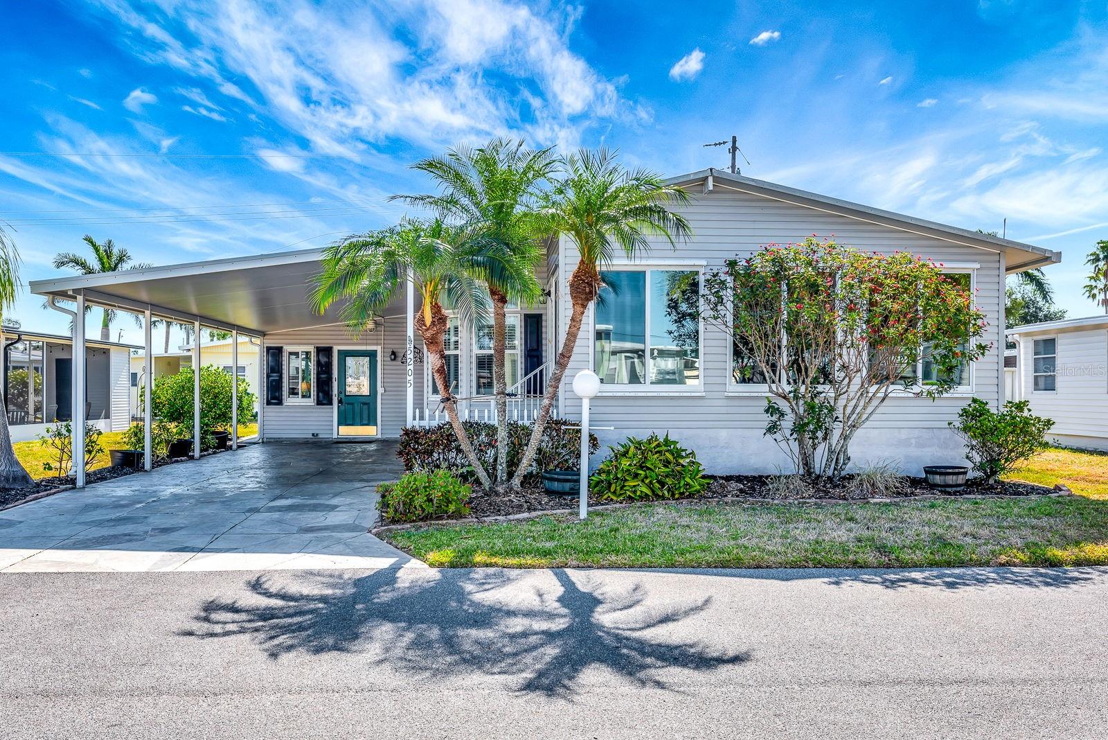 One or more photo(s) has been virtually staged. Welcome to this charming 2-bedroom, 2-bathroom manufactured home located in the highly sought-after Golf Lakes community of Bradenton, a 55+ neighborhood offering exceptional amenities and an active lifestyle. Recent upgrades include a 2020 central A/C, 2024 water heater, and a 2017 roof, plus hurricane shutters for added peace of mind. Step inside to find a light and bright interior with an open living room/dining room combo and plantation shutters throughout, providing both style and privacy. The front living room is a great space to relax or entertain guests, and the indoor washer and dryer add convenience. The kitchen features a new stainless steel refrigerator, ample storage, and easy flow into the main living areas. The spacious primary bedroom includes a private attached bathroom, and both bedrooms offer comfortable accommodations for guests or daily living. Some furnishings are included, making this home move-in ready! Enjoy the Florida lifestyle outdoors under your carport or take advantage of the community’s many amenities, including a heated pool and spa, 9-hole golf course, fitness center, pickleball and tennis courts, shuffleboard, lakes for fishing, and picnic areas. The clubhouse hosts regular activities and social events, ensuring there’s always something fun to do. Located close to shopping, grocery stores, restaurants, and banks, you’ll have everything you need within minutes. The affordable HOA fees include water, sewer, trash, cable TV, and internet – simplifying your monthly expenses. Don’t miss this fantastic opportunity to own a comfortable, updated home in one of Bradenton’s most vibrant 55+ communities! Schedule your tour today!