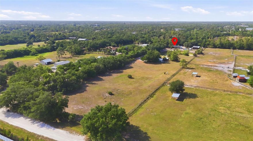 Tucked away along a picturesque, tree lined drive, this peaceful five acre homestead in Wellington Acres offers a rare blend of privacy, charm, and equestrian lifestyle. Set on Morningside Drive, the property welcomes you with a classic Old Florida residence featuring a charming front porch overlooking a pond where two beautiful horses roam freely, an everyday scene that feels nothing short of magical.
The home offers 2 bedrooms and 2 bathrooms, with a thoughtfully updated kitchen complete with granite countertops and ample cabinetry. The adjoining dining area is perfectly positioned beside a large window, capturing views of the land and water beyond. Built in 1971, the home is solidly constructed and has performed exceptionally well through recent hurricane seasons, offering both character and peace of mind.
For equestrian enthusiasts, the property includes a four stall barn with a dedicated tack room, along with installed fans to ensure comfort during the warmer months. The grounds allow horses to roam and even enjoy the pond, creating a truly special environment.
Additionally, the property features a fully functional doggy dorm and playground, currently operating as a dog daycare and boarding business. Whether you choose to continue the existing operation or simply enjoy it as a private haven for your animals, the possibilities here are both practical and inspiring.
A unique opportunity to own a serene, versatile property that captures the essence of country living with thoughtful amenities already in place.