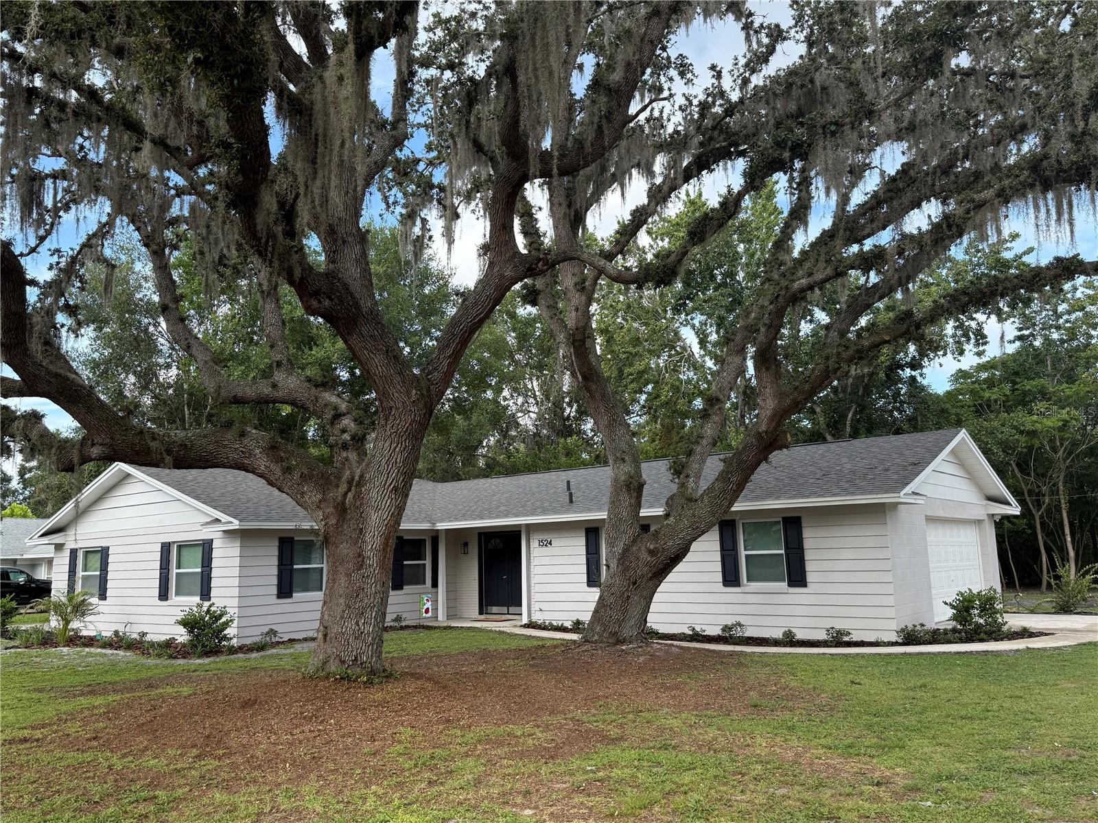 Completely renovated and move-in ready, this stunning home at 1524 Hillway Rd in Apopka offers deeded access to Bear Lake—one of Central Florida’s premier ski lakes—perfect for boating, skiing, and year-round water activities. Nestled in a peaceful, country-like setting on a large, wooded lot, this property also features the added benefit of no HOA to limit your lifestyle, so bring your RV and boat! The home has been extensively updated from top to bottom, including a brand-new roof, new HVAC system, new electric panel, new hot water heater, new windows, new insulation, and a new water system. Inside, you’ll find a fully remodeled kitchen with quartzite countertops, new cabinetry, and new stainless-steel appliances, along with updated bathrooms featuring modern vanities and new tile. Step out onto a spacious, covered back porch that stretches the entire length of the home. Additional upgrades include new flooring throughout and fresh interior and exterior paint. Conveniently located near I-4 and SR 429, this home combines high-quality finishes, a spacious private lot, and access to Bear Lake—all without the restrictions of an HOA. Don’t miss this rare opportunity—schedule your private showing today.