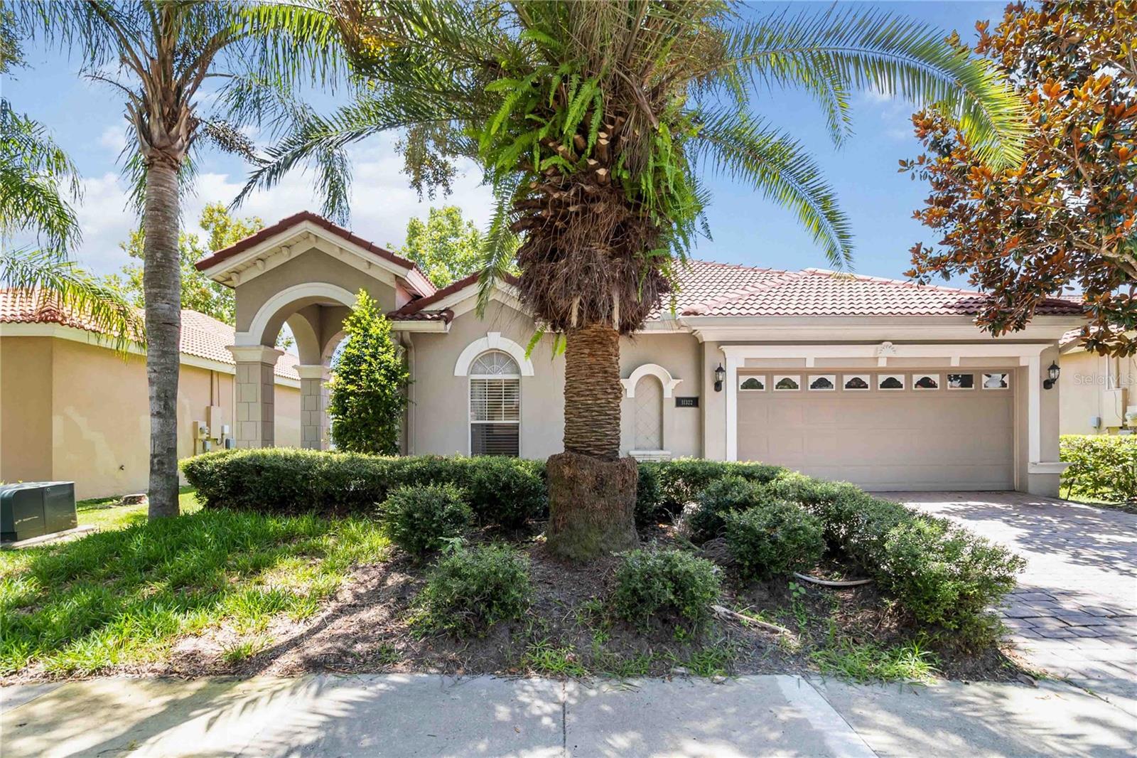 One or more photo(s) has been virtually staged. "Bundled service pricing available for buyers. Connect with the listing agent for details." Located in the gated Windermere community of Belmere Village, this beautifully maintained 4-bedroom, 2-bathroom home offers both comfort and convenience. Residents enjoy low HOA fees and a wealth of amenities including a clubhouse, fitness center, resort-style pool, playground, basketball and volleyball courts, and newly added pickleball courts. With top-rated schools nearby and easy access to major highways, shopping, dining, and Orlando’s world-renowned theme parks, the location is truly unbeatable. Step inside to a modern floor plan with flexible spaces for living and dining. Tile flooring runs throughout the main living areas and durable plank flooring in all bedrooms. The eat in kitchen features stainless steel appliances, 42” warm wood cabinets, and Corian countertops. The spacious primary suite includes his-and-her closets, dual sinks, a soaking tub, and separate shower. Spacious secondary bedrooms offer flexibility for guests or a home office and share a well appointed bathroom. Enjoy outdoor living in the partially enclosed, screened-in lanai and fenced backyard. Additional highlights include a low-maintenance yard, paver driveway, and durable tile roof. Perfectly situated just steps from the community amenities—this is Windermere living at its best.