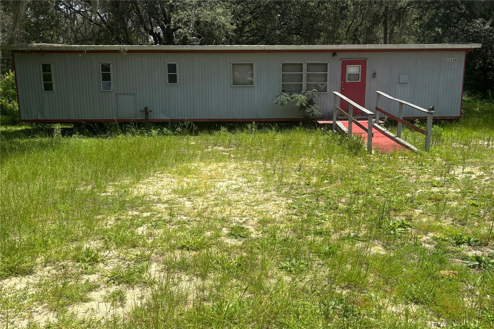 Affordable and move in ready! Property has been vacant for a year, power is on, but breaker is off. For inspection purposes the breaker box is in the bedroom. Turn breaker off when done. double pan roof over on 2/1 furnished 12x48 mobile home. additional lot has old well on it. partly fenced. Just off paved road maybe 400ft or so. At this price HURRY it will not last.