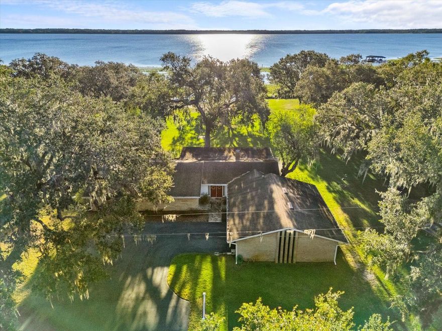 One or more photo(s) has been virtually staged. Experience the Magic of Lakeside Living!

Welcome to your own slice of paradise! Nestled on 6.21 peaceful acres along the shores of Alligator Lake in beautiful Saint Cloud, this property is located on a quiet cul-de-sac, offering the perfect blend of privacy and comfortable living. Surrounded by graceful oak trees and a tranquil forest, it’s a place where you can truly relax and unwind. The main house features 3 bedrooms and 2.5 bathrooms, designed to make everyday living cozy and convenient. Large windows bring in stunning views of the lake and the lush greenery, making you feel connected to nature at every turn.

There’s also a charming guest house with 1 bedroom, 1 bathroom, and an office space that can easily be converted into another bedroom if needed. For hobbyists or those needing extra space, the three-bay shop is ready for projects, storage, or both! The highlight of this property is its lakefront access—imagine starting your mornings with a cup of coffee, watching the sunrise dance across the water, or spending your afternoons fishing, boating, or strolling through your very own paradise.

With its prime location, expansive acreage, and no HOA, this property offers endless opportunities for customization, hobbies, or simply enjoying the peace and beauty of lakeside living. Tucked away for privacy yet still close to local amenities, this Saint Cloud retreat truly has it all. Don’t miss the chance to make this lakeside haven your forever home—schedule your showing today!