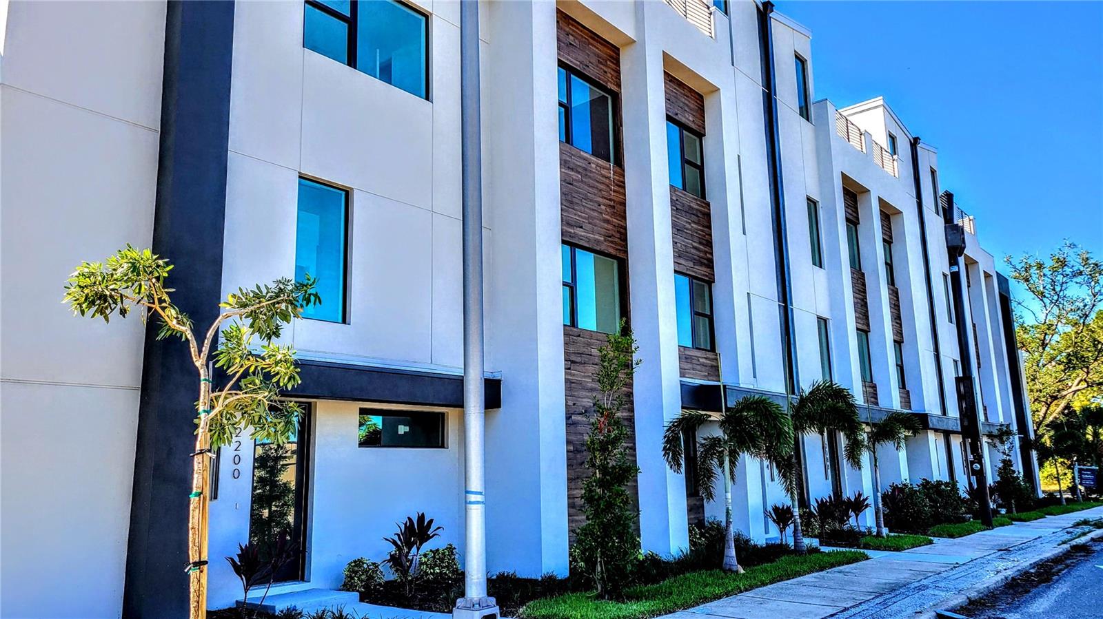 Annual unfurnished BRAND NEW, WELL CONSTRUCTED, amazing townhome that is flooded with natural light show casing large rooms with high end finishes, lighting, tall ceilings and comfortable stylish design. Come on in the front door or access thru rear 2 car garage with epoxy flooring, an entry with laundry, elevator or staircase, that lead to an open and exciting entertaining living area on the 2nd floor. This kitchen is large with a huge island with breakfast bar and waterfall quartz counters and pendant and accent lighting. Loads of solid wooden cabinetry, custom tile backsplash and complimented with stainless steel appliances are adjacent to the dining area and great room. The next floor up holds the bedrooms. The main bedroom is spacious with ensuite bathroom-dual sinks, walk in shower and big walk in closet. The 2nd bedroom has access to another full bathroom. The roof top has an exceptional outdoor living area with an outdoor kitchen area, and room to spread out and enjoy the city views. This property has been built to last with solid block construction. You will find this location is close to shopping, casual and fine dining, theater, opera, museums, library, and the beach. It's time to come home to a really special place in downtown Sarasota. This community is governed by a homeowners association. Approval may include an application, background screening, fees, and an approval process. Contact the agent for details. Call today!