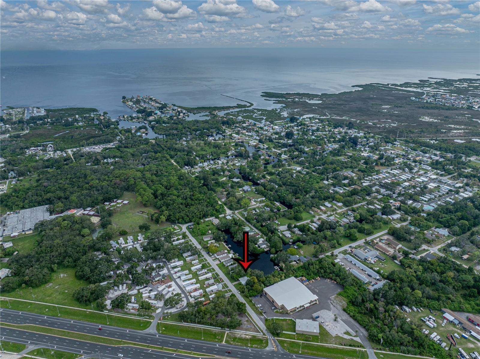 Nearly a 1/4 acre of waterfront living is waiting for you in central Hudson! This unique property includes ownership of a portion of the private canal out back, giving you direct access to the water, only minutes from the Gulf of America. With about half of the lot on land and half on water, it’s an ideal setting for building your dream home in a true Florida paradise. Both manufactured and single family homes are permitted! A tropical landscape surrounds the property, creating a lush backdrop for relaxation and easy coastal living. Don’t miss this chance to own a rare waterfront lot in such a convenient location; come see it today.