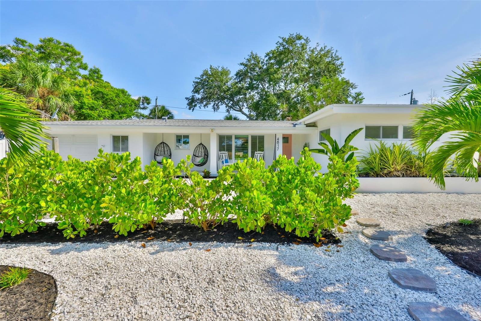Experience modern coastal living at its finest in the heart of Gulfport’s sought-after Marina District! Just a block to the marina and within one mile of everything Gulfport has to offer—no chain stores, no parking meters, just pure Old Florida charm. This stunning 2-bedroom, 2-bath single-family POOL home is a true showstopper. While it did experience water intrusion of 10 inches during a rare 1/100 year storm, it has been professionally restored—and now shines even brighter. From the moment you arrive, prepare to be wowed. Step onto the welcoming front porch, where a cozy swing and sitting area invite you to enjoy your morning coffee or evening cocktail amid the beautifully designed, low-maintenance xeriscape yard. Inside, a light-filled open floor plan connects the brand new kitchen, dining, and living areas—all with views of the sparkling salt water pool. Gleaming polished terrazzo floors run throughout, adding a modern yet timeless touch. The gourmet kitchen is a dream, featuring all-new Samsung Bespoke appliances, a farmhouse sink, butcher block countertops, floating shelves, and a quartz-topped island perfect for entertaining. The spacious primary suite offers two closets and an en suite bath with a walk-in shower. French doors lead to your private backyard oasis—complete with salt water pool enclosed by a brand new screened lanai with UV protection, and a cozy fire pit area just beyond. Whether it’s a sunny pool day or a starlit night by the fire, this backyard is built for relaxation. Additional highlights include a laundry and storage area with direct pool access, and an oversized one-car garage. Located just blocks from Gulfport’s historic downtown waterfront village, with easy access to fishing, dining, shopping, the Gulfport Casino, parks, beach, and community center. With events like the Tuesday Fresh Market, First Friday Art Walk, and 3rd Saturday IndieFaire, there’s always something happening in this vibrant, funky town.