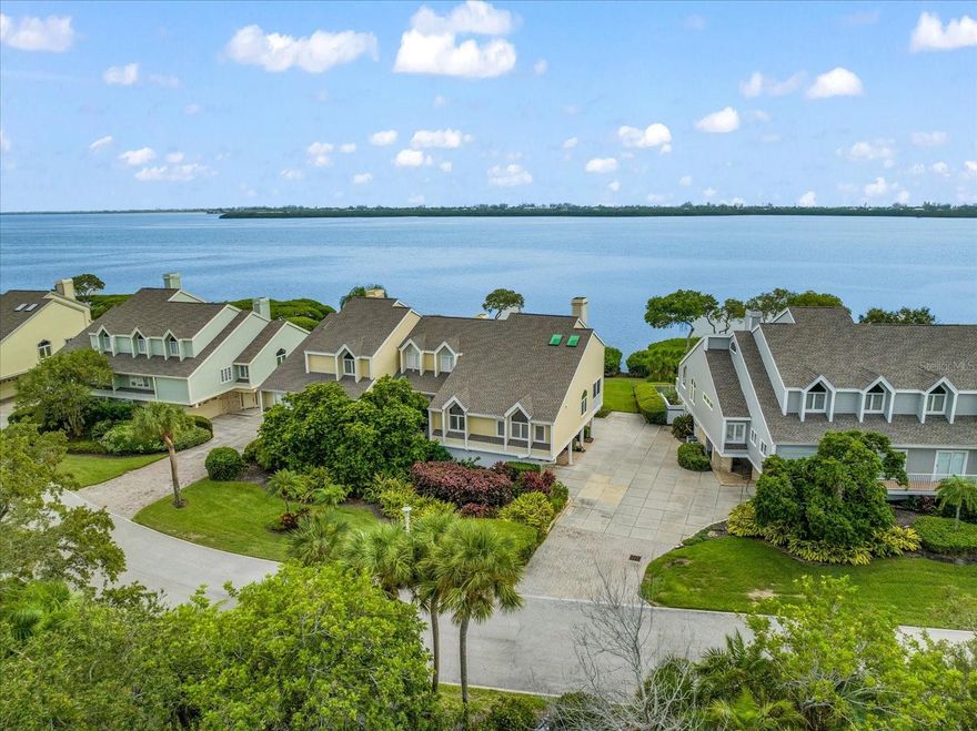 Ideal coastal retreat nestled in the heart of Sarasota Bay. This immaculate 3-level townhome, boasting panoramic views of the bay, has been meticulously updated with an updated kitchen and contemporary baths, ensuring a seamless blend of modern comfort and timeless elegance. With a spacious dining room adorned with vaulted ceilings and an inviting ambiance, this home is perfect for hosting intimate gatherings or enjoying quiet family dinners. Step inside to discover the seamless flow of wood floors throughout, exuding warmth and sophistication at every turn. The allure continues with a large balcony offering breathtaking vistas, as well as a charming screened porch for those cozy moments. This home features 2 bedrooms with an additional loft space, providing ample room for relaxation and privacy. Unwind and entertain effortlessly with the convenience of a well-equipped wet bar, while the 2-car garage and storage room offer practical solutions for all your storage needs. Situated on the desirable west end of the island, this community offers a host of exclusive amenities, including access to inviting pools, a soothing spa, scenic trails for leisurely strolls, and welcoming gathering spaces for fostering connections with neighbors. With 24/7 gated security, you can enjoy peace of mind and security throughout the year. Embrace the local culture and heritage with easy access to the nearby history museum, or explore the natural wonders of the bay with a boardwalk and kayak launch just steps away. Convenience is at your fingertips, with the pristine beaches, the SRQ airport, and the bustling downtown area all within easy reach. This townhome presents an unrivaled opportunity to live the quintessential coastal lifestyle you've been dreaming of. Seize the chance to experience the best of Sarasota Bay living - schedule a viewing today and unlock the door to your new chapter of serene coastal living. Two Brand New A/C UNITS 10/2025