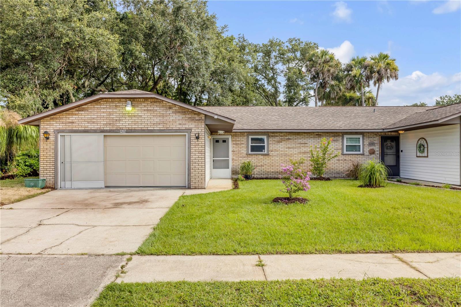 Step into this recently updated, move-in ready 2-bedroom, 2-bathroom half-duplex with a 2-car garage, offering the perfect blend of comfort, style, and convenience. Bright and inviting, the open floor plan features low-maintenance tile flooring and plenty of natural light throughout. The thoughtfully designed kitchen is a standout, complete with solid surface countertops, shaker-style cabinetry, tile backsplash, and stainless steel appliances that flows seamlessly into the dining area, ideal for everyday living or entertaining. Enjoy a spacious living room with sliding glass doors that open to the fenced-in backyard with new sod, creating an effortless indoor-outdoor experience. The generous primary suite includes a private en-suite bathroom, while the second bedroom and full bath are perfect for guests or a home office. Located just minutes from shopping, dining, and the beach, this gem won’t last long—schedule your showing today!