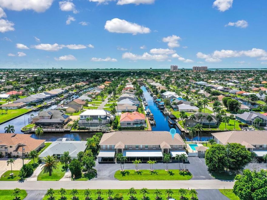 Experience waterfront living at its finest in this beautifully remodeled 2-bedroom, 2-bath condominium, perfectly situated on a direct Gulf-access canal with mesmerizing intersecting water views. As an end unit, this residence is bathed in natural light, enhancing its open and inviting feel. Every detail has been thoughtfully upgraded, offering a move-in ready home that blends modern style with timeless coastal charm. Step inside to find luxury vinyl plank flooring flowing seamlessly throughout, creating a cohesive and low-maintenance backdrop for everyday living. The kitchen is a true showpiece with crisp white shaker cabinetry, elegant quartz countertops, and plenty of storage space, ideal for both casual meals and entertaining. Both bathrooms echo the same high-end finishes, with the primary suite a spacious walk-in closet, a separate water closet, and a sleek walk-in shower for a spa-like retreat. Additional upgrades include plantation shutters on every window, in-unit laundry for convenience, and a newer HVAC system for peace of mind. Offered unfurnished, with some items negotiable, the home is ready for you to add your personal touch. The community itself is designed for those who love the Florida lifestyle. Spend sunny afternoons lounging by the sparkling pool, or take full advantage of the community boat dock equipped with water and electric, where slips are assigned through the association. With direct access to the Gulf of Mexico, boating and fishing adventures are just moments away. This is more than just a condo—it’s a true waterfront sanctuary where every day feels like a vacation. Whether you’re seeking a year-round residence or a seasonal escape, this home delivers the perfect blend of style, comfort, and location. Don’t miss the chance to wake up to sweeping canal views and enjoy all the best that Cape Coral has to offer.