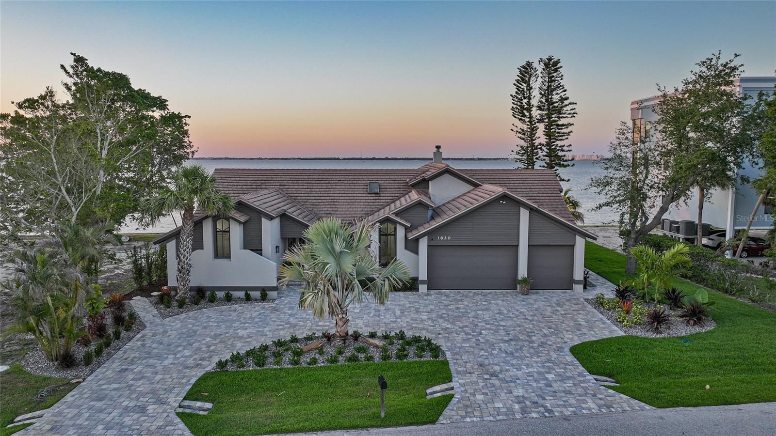 Prepare to be captivated by the breathtaking water views and timeless elegance of this furnished, move-in-ready estate located on one of Punta Gorda Isles’ most coveted streets — Jamaica Way. This 4-bedroom, 3.5-bath home offers an exceptional blend of coastal sophistication and everyday comfort, with over-the-top features designed for luxury living. Positioned along deep sailboat water with quick access to Charlotte Harbor, the views are nothing short of spectacular — enjoyed from nearly every room in the home and showcased beautifully from the expansive pool and lanai area. Step inside to soaring cathedral ceilings, sleek luxury vinyl plank flooring, and abundant natural light. The open-concept layout features a chef’s kitchen equipped with a stand-alone freezer, second refrigerator, toaster oven, and oversized pantry — perfect for entertaining in style. Custom plantation shutters, impact glass doors, and a wood-burning fireplace add warmth and character, while the central vacuum system provides effortless convenience. Retreat to the spacious primary suite with water views, pool access, and a spa-like en-suite bath. The additional three bedrooms provide plenty of space for guests or family, all with elegant finishes and ample storage. Outside, the lanai is your private tropical paradise. Take a dip in the sparkling pool, dine al fresco, or simply soak in the uninterrupted waterfront scenery. The 3-car garage offers room for all your toys, while it includes home’s furnishings (except personal items such as artwork) make moving in a breeze. Whether you're hosting sunset gatherings by the water or enjoying peaceful mornings with a cup of coffee poolside, 1820 Jamaica Way is your dream Florida lifestyle come true.