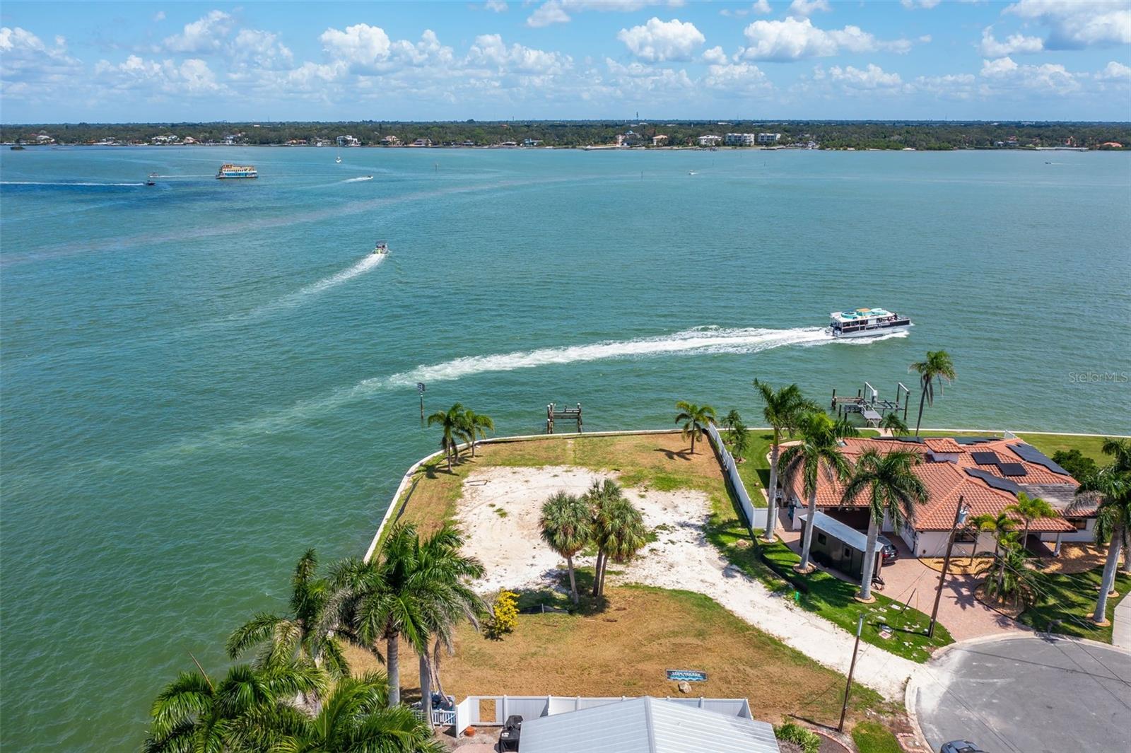 Build Your Waterfront Dream! Rarely available, oversized lot at the end of a quiet cul-de-sac on Capri Isle, boasting over 240 feet of prime waterfront. This is your chance to create a custom home in one of the most desirable waterfront neighborhoods on Florida’s west coast.
Enjoy uninterrupted views of the Intracoastal Waterway in every direction, with easy access to the Gulf of Mexico just minutes away by boat. Watch dolphins and manatees glide by, enjoy stunning sunrises and sunsets, and take in the sights and sounds of this serene waterfront paradise. The generous lot size provides ample space for a substantial custom home, a pool, and a boat dock capable of accommodating nearly any vessel. The process for installing a new seawall is already underway and included in the price. The new seawall will be built to maximum allowable height and the land will be backfilled for future flood prevention. This amazing property affords the opportunity to dock multiple vessels, including large yachts. The water depth is sufficient just a few feet from the seawall, as well as Gulf access just minutes away. Opportunities like this are rare — premier waterfront lots on Capri Isle rarely come to market and this one is EXTRA SPECIAL. Don't miss the chance to own this premier waterfront location.