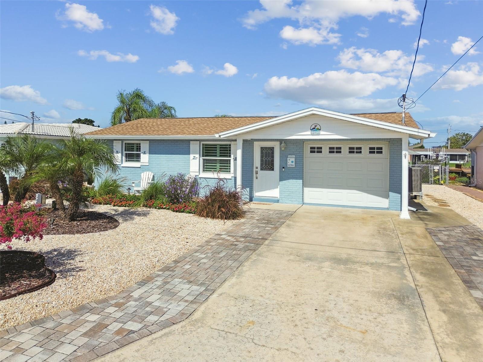 Charming Waterfront Retreat in Leisure Beach! Welcome to this beautifully updated concrete block home in one of Hudson’s most desirable waterfront communities—Leisure Beach. This property features 2 bedrooms, 1.5 baths, plus a versatile bonus room ideal for a guest space, home office, yoga studio, or playroom. Inside, you’ll love the coastal-inspired design with porcelain tile floors throughout, fresh beachy color palette, and 4” plantation shutters. The kitchen boasts new soft-close cabinetry, stainless steel appliances, and subway tile backsplash. Additional upgrades include hurricane-rated windows and doors, tamper-proof safety outlets with USB chargers in every room, and an updated electric panel with an RV hookup. Enjoy year-round relaxation in the spacious all-season screened lanai overlooking a fully fenced, beautifully landscaped backyard—perfect for pets or children. Step outside to your waterfront oasis: a 12’x12’ deck under swaying palms, a floating kayak dock, and an 8,000 lb boat lift with walk-out deck for easy access to the Gulf. With no bridges to navigate, you’ll be fishing, island-hopping, or visiting waterfront restaurants in minutes. After a day on the water, rinse off in the outdoor shower with hot/cold water and unwind under the lighted palms in your coastal-inspired yard, complete with a large storage shed for all your boating gear. This home truly embodies Florida waterfront living—don’t miss your chance to make it yours!
(ROOF-2014)(A/C-2015)(WINDOWS/IMPACT-2016)