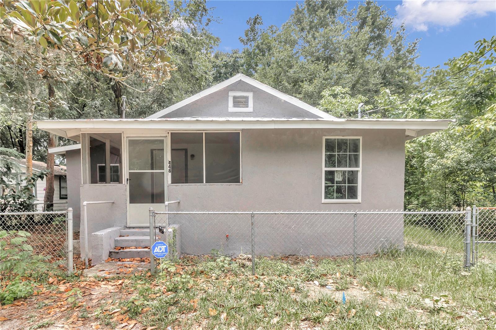 Under contract-accepting backup offers. NEW 2024 METAL ROOF !!’A lot of bang for the buck in this four bedroom two bath, completely renovated and updated home close to downtown Ocala! The property offers front porch, screened in area leading to open and modern floor plan with brand new kitchen, modern cabinets, and stainless steel appliances with new sink. The split bedroom plan offers the perfect privacy with the primary bedroom being in the back of the home. Everything is new in the home all the way down to the plumbing and drywall, but also includes the AC, windows, electrical, electrical panel, all the bathrooms are brand new and beautiful, modern finishes, new flooring, new hot water heater, new drywall and new plumbing. The property has full perimeter fence yard and large spacious workshop or garage in the backyard. This property sits on a dead street and has no HOA! No blind offers