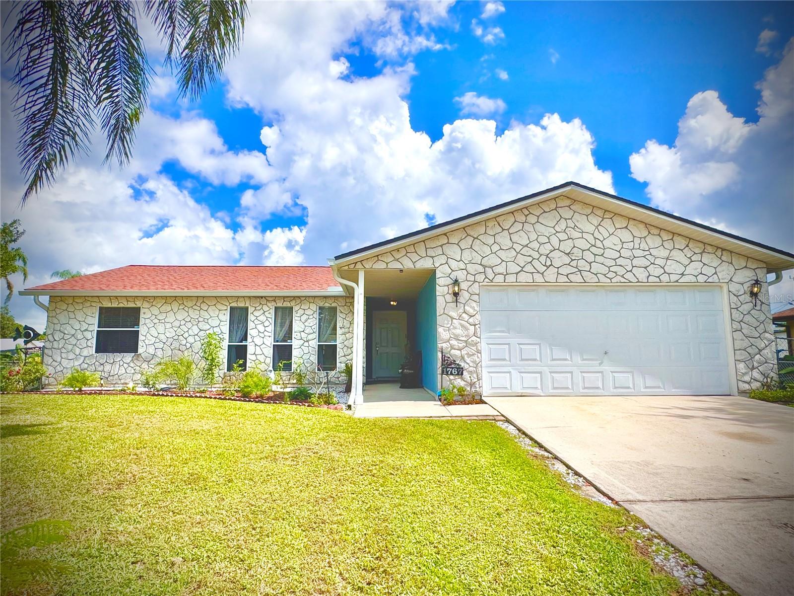 Very well maintained 3/2 home with 2 car garage, partially converted to workshop and laundry area, resting on fenced in 0.23 acres with enough space for a pool. New ROOF installed 2023 same as HVAC with 2 UV sanitizing lights to maximize efficiency and keep allergens away. Brand new gutters recently installed. Living and dining room feature high vaulted ceilings, new vinyl flooring throughout living room, primary bedroom and one of the bedrooms. Rest of the home is tiled except one bedroom with carpet. Spacious kitchen with solid wood cabinets and new stainless steel appliances range hood included. Kitchen window overlooking large covered and screened in back porch entering through updated dining room sliding doors. This porch is ideal for outdoor dining and entertainment with friends and family. Harvest own fruit from variety of trees - banana, papaya, mango, red grapefruit, avocado and fig. Nice shed to store all garden tools. Tucked away but few miles from shopping plaza and schools; Ted Whitlock Community Center; Palm Bay Regional Dog and Disc Golf Park; Brevard Soccer and Baseball fields. This affordable property with public water and septic tank (inspected 2023) has everything needed to live comfortably without any HOA restrictions plus underground electrical wires just being installed! Come see it today and start living your Florida lifestyle tomorrow!