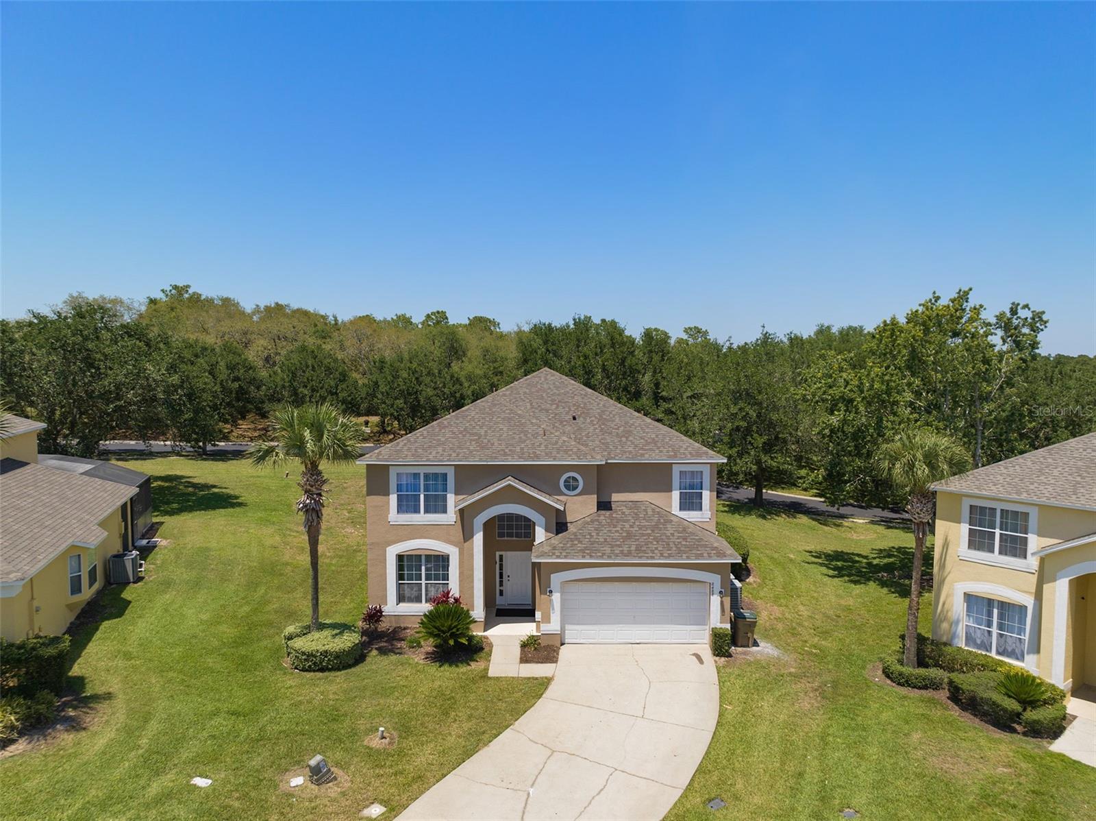This spacious 7-bedroom, 4.5-bathroom single-family pool home in the gated Emerald Island Resort checks every box for the savvy investor. With 2,914 sq. ft. of living space on an oversized 10,149 sq. ft. cul-de-sac lot, this fully furnished home is a heavily booked short-term rental located less than 5 miles from Walt Disney World. Step outside to a large screened-in pool and spa with a newly resurfaced finish (2022), expansive covered deck, and plenty of room to lounge in the sun or shade. Inside, you’ll find a bright and open layout with a spacious kitchen, family room, and two owner’s suites plus five additional bedrooms, perfectly designed for large families and groups. A dedicated game room adds extra entertainment value for guests. Recent upgrades make this a worry-free investment: 2 new A/C units & pool motor (2022), new roof & exterior paint (2019), new water heater with garage A/C function, new sliding glass door to pool (2023) ,new flooring (2023) for staircase, upstairs bedrooms, and downstairs master, new countertops throughout, garage floor epoxy (2023), custom feature walls in all rooms. Emerald Island Resort offers resort-style amenities including a clubhouse with fitness center, tiki bar, sauna, spa, tennis courts, mini golf, playground, and community pool. Conveniently close to Disney, Universal, SeaWorld, shopping, dining, and all Orlando attractions. Venture a little further and enjoy world-famous beaches, both the Space Coast and Gulf Coast are just about an hour away. This property is short-term rental approved, fully furnished, and income-producing from day one. Whether you’re looking to expand your vacation rental portfolio or secure a proven Disney-area investment, this home is a must-see.