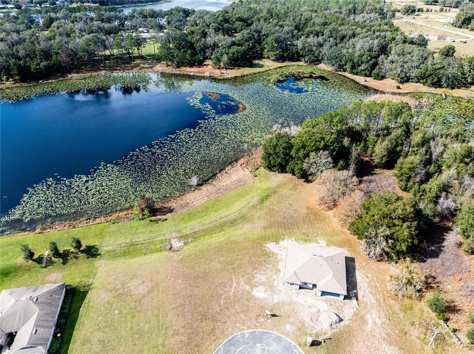 Lakefront!! This lot is the most extensive lakefrontage available in the community to build on. It has a sprawling 146 feet on the lake. This lot already has a built-up pad, public water, public sewer, and electricity available and ready to build. No need for clearing! Bring your house plans and enjoy this fantastic, sought-after community. The gated 55+ community has a pool, so you do not have to worry about maintenance. This location is just minutes from grocery, entertainment, churches, parks, and much more. Come see it for yourself so you can see how your dream home will look overlooking the lake.
