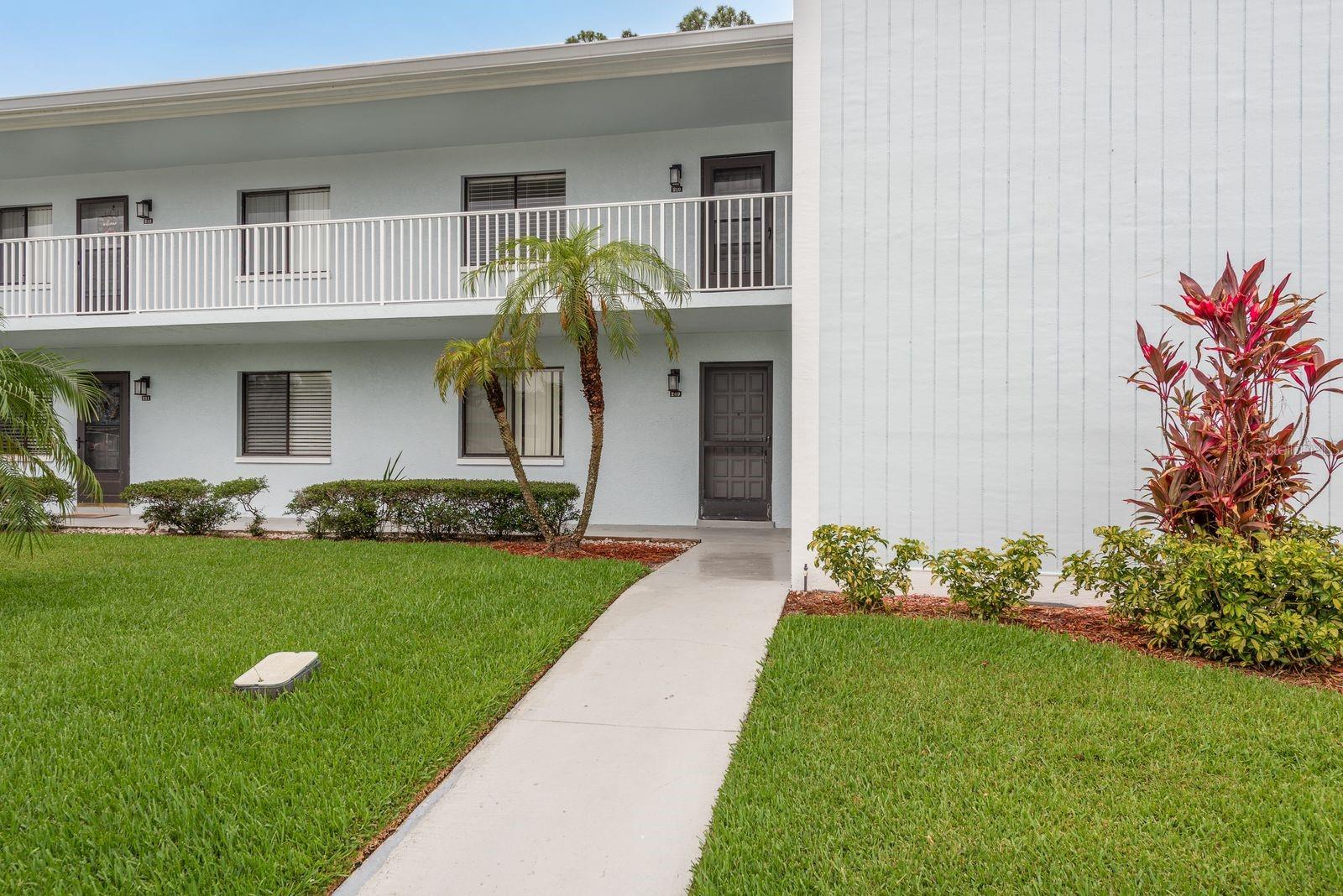 Welcome to this charming 2-bedroom, 2-bathroom condo in the highly sought-after gated community of East Lake Woodlands. Featuring a new A/C system (2022) and located just across from the community pool, this unit offers the perfect blend of comfort and convenience. The open split floorplan provides plenty of space for both relaxing and entertaining. The living room boasts a wood-burning fireplace and sliding glass doors that lead to a screened-in balcony overlooking a peaceful pond and mature trees—the perfect spot to unwind and enjoy the Florida breeze. The kitchen is outfitted with stainless steel appliances including a refrigerator, dishwasher, and microwave, along with a separate pantry for added storage. The spacious primary suite features three walk-in closets and an en-suite bath with an updated vanity and tiled walk-in shower. The second bedroom is conveniently located near the guest bathroom, also featuring modern finishes. Additional highlights include a full-sized washer and dryer, ample in-unit storage, and assigned carport parking. The monthly condo fee includes cable, trash, sewer, water, and more! Enjoy a prime location across from the AMC Woodlands movie theater, a shopping center with a variety of restaurants, and just minutes to more shopping, dining options, and a short drive to the beautiful Gulf beaches. Whether you're seeking a full-time residence, a seasonal retreat, or a smart investment, this move-in-ready condo has it all!