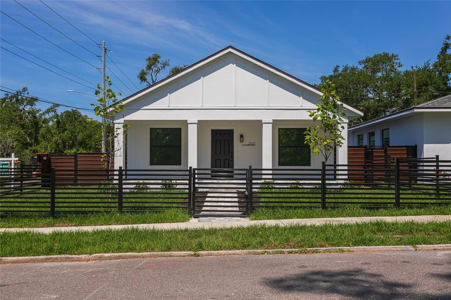 New construction unique single story home with attached ADU. Two independent homes under 1 roof. Ideal for multigenerational living, comfortable guests hosting or rental income. Main house has 3 split bedrooms and 2 bathrooms. Attached ADU (accessory dwelling unit) has 2 bedroom, 1 bath with a full kitchen and own laundry. Main home has 2 private (front and rear) entrances with private porches, ADU has its own private entrance with private porch and private parking. Solid wood interior doors, 6 inch baseboards, built in ovens, induction cooktops, remote controlled quiet ceiling fans in all bedrooms, to ceiling solid wood soft closing kitchen cabinets, flush microwaves, new generation ventless washer/dryer combos, composite kitchen sinks, lot of storage space in vanities and bathroom cabinets and paved sidewalks.  Addresses, electric and water meters are separate, so you can rent the Main house, ADU or both. Both houses are light and bright with hight ceilings, built with reinforced concrete block, hurricane windows and doors, lots of energy efficient features like spray foam insulation and low-e impact windows. Both homes have  quartz countertops and luxury vinyl plank flooring. Stainless steel Samsung appliances packages in both kitchens covered with 5 years extended warranty. Property fully landscaped with automatic irrigation system. Both units have private separated parkings: 2 car for main house and 1 car for ADU off the alley. This unique property located right opposite of YMCA, 1 minute walking to Dell Holmes Park, within 5 minutes driving to Downtown St. Pete and 15 minutes driving to beaches. Homes come with 1/3/10 warranty. NO FLOOD INSURANCE REQUIRED. NO HOA. NO CDD.