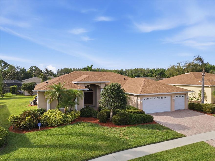 REFINED, RELAXED & COMPLETELY AT HOME. Nestled in La Paloma, a quiet pocket of southern Hillsborough County known for its space, privacy, and golf course lifestyle, this home is set upon a spacious quarter-acre lot and makes a sophisticated first impression. Its understated curb appeal offers a quiet elegance that hints at the refined luxury waiting just beyond the front door. The moment you step inside, the soaring ceilings and the flowing layout make the home feel expansive and welcoming. The living spaces flow effortlessly with one another, and the massive sliding glass doors flood the home with light, creating a seamless transition to the outdoors. No matter where you find yourself in the heart of the home, the view of the shimmering pool follows. It’s more than just a feature; it’s a constant backdrop of tranquility that confirms you are exactly where you were meant to be. The primary suite serves as a private sanctuary where direct pool access transforms quiet mornings into a daily resort experience. The floor plan is thoughtful and functional, providing an abundance of room for your family while maintaining that connected and cohesive feel. Step outside to find the pool taking center stage, exactly as it should. This elegantly sculpted oasis is framed by spacious lounge areas for effortless poolside conversation. With delightful views of nature and the golf course, it offers the perfect backdrop for sun-drenched afternoons and intentional outdoor entertaining. The 3-car garage, irrigation system, and well-established landscaping make maintenance a breeze so you can focus on enjoying that Florida lifestyle you've worked so hard for. La Paloma Village is golf-cart friendly and anchored by Cypress Creek Golf Club, with a second executive course just a short ride away. Tampa International Airport, St. Joseph's South Hospital, and MacDill AFB are all within easy reach, and the location puts Tampa, St. Pete, and Sarasota all well within reach whenever you want them. This is the kind of home that makes you stop looking once you find it.