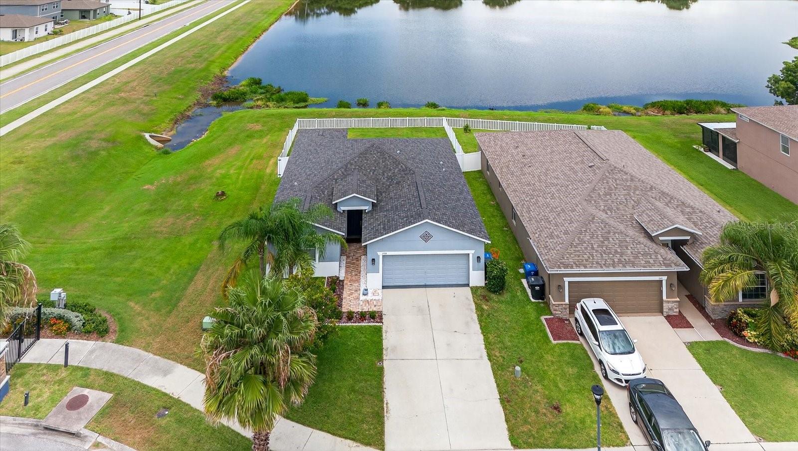 Enjoy endless sunsets with water views in this 3BR/2BA/2CG home located in the gated Hawks Point community. This move-in ready home features brand new luxury waterproof vinyl flooring throughout, fresh interior paint, and no rear neighbors. The open kitchen offers granite countertops, 42" espresso cabinets, stainless steel appliances, recessed lighting, and a double pantry. Split floor plan with spacious primary suite featuring water views, dual walk-in closets, dual sinks, soaking tub, and glass-enclosed shower. Guest bedrooms have ample closet space and ceiling fans. Relax on the screened patio overlooking the backyard. Community amenities include resort-style pool, fitness center, clubhouse, playground, and dog park. Conveniently located near schools, shopping, dining, public boat ramps, Little Harbor Beach, and I-75