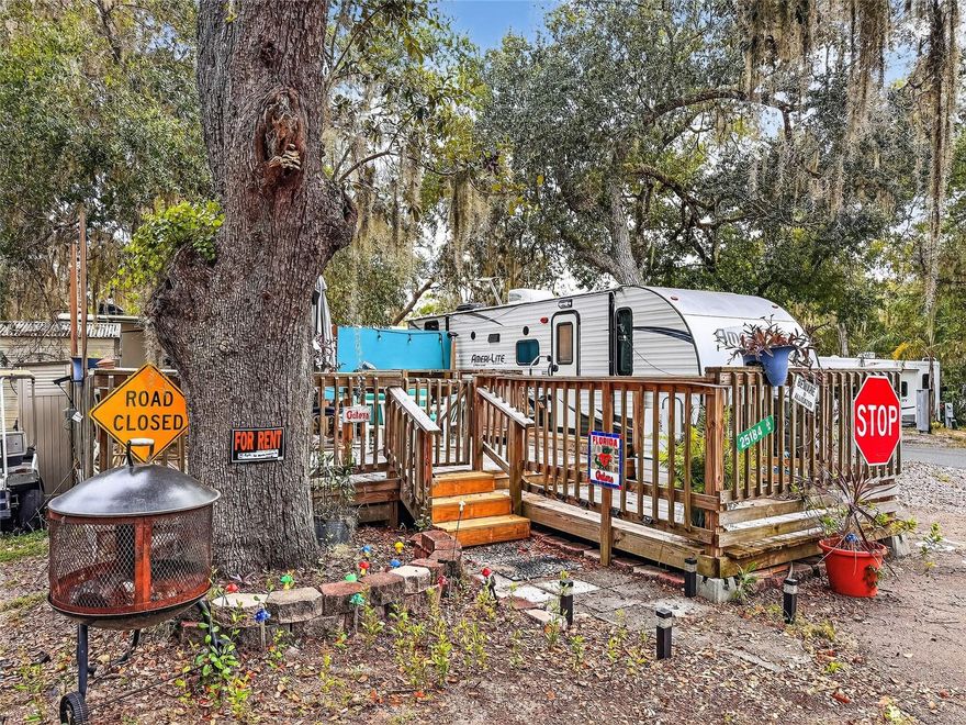 Income producing lot with 2017 RV connected to public sewer and water. Fully furnished and Turn key Low HOA fees.  Aribnb friendly, current owner is charging $100 a night. Newer deck built with firepit. Tons of amenities to include private boat ramp, pool, clubhouse/food shack, dog park and golf cart friendly.
