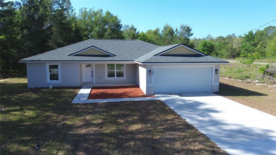 Just what you’ve been looking for! This brand-new NEW CONSTRUCTION home offers the perfect mix of comfort, style, and privacy in the peaceful wooded community of Ocklawaha. Designed with an OPEN CONCEPT layout and desirable SPLIT BEDROOM floor plan, this home is packed with standout features including QUARTZ COUNTERTOPS, CEILING FANS THROUGHOUT, a CORNER PANTRY, KITCHEN ISLAND, and a COVERED REAR LANAI. Step inside to discover VAULTED CEILINGS enhancing the bright main living area, where the spacious living and dining spaces flow seamlessly into a true COOK’S KITCHEN complete with a large breakfast bar island, STAINLESS STEEL SAMSUNG APPLIANCES, pantry storage, durable LVP flooring throughout, and impressive 42” SOFT-CLOSE CABINETS. The kitchen is designed to impress with a stunning QUARTZ WATERFALL ISLAND, creating a focal point with plenty of room for entertaining with a nice view for the backyard. The PRIVATE PRIMARY SUITE is tucked away on one side of the home and features a TRAY CEILING, WALK-IN CLOSET, and a beautifully appointed bath with DUAL SINKS, quartz counters, a CERAMIC TILE SHOWER with rain shower head, a beautiful niche, and a SEPARATE TOILET ROOM. On the opposite side, two generously sized guest bedrooms share a full bath with a quartz countertop and elegant PORCELAIN TILE finishes, while additional upgrades include SOFT-CLOSE CLOSET DOORS in the bedrooms for a refined touch. The OVERSIZED GARAGE easily accommodates trucks with 8-ft beds, adding extra flexibility and function. Enjoy the outdoors year-round from the COVERED REAR LANAI and COVERED BACK PORCH, perfect for relaxing while appreciating the added privacy of NO REAR NEIGHBORS at this point in time. Ideally located between The Villages and Ocala, and nestled between the fresh water LAKE WEIR for boating, CARNEY ISLAND RECREATION & CONSERVATION AREA so you can enjoy hiking trails, lake side beaches, and much more! Near the area, the OCALA NATIONAL FOREST featuring natural pools, canoe runs, and hiking trails! This home offers a secluded feel without sacrificing convenience. Best of all, there is NO HOA, NO CDD so bring your toys and enjoy the freedom. A beautifully upgraded home in a growing area ready for its new owners.