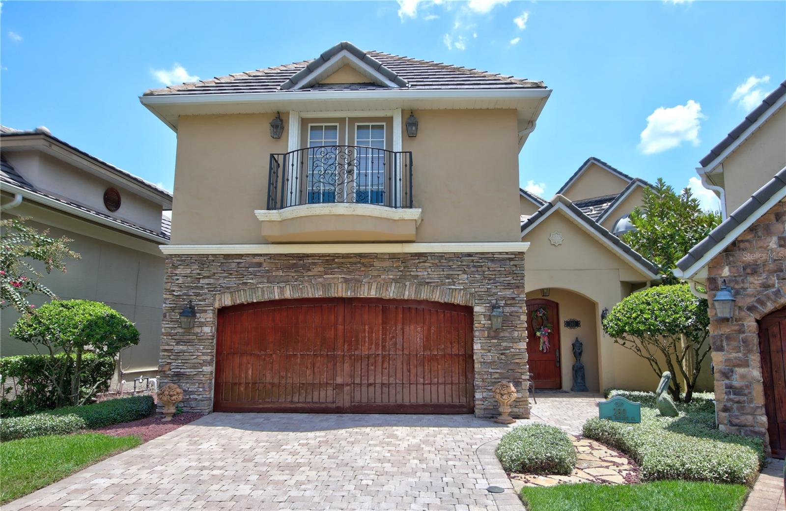 Experience old-world elegance and modern luxury in this stunning European-style villa located directly on the golf course. From the moment you arrive, a dramatic gated courtyard entrance welcomes you with a cozy outdoor fireplace and tranquil Koi pond with cascading waterfall—setting the tone for the unique charm and sophistication found throughout this extraordinary home. Just before entering the main house, discover a detached second-floor guest suite with its own private entrance—ideal for an In-law suite, studio, or private home office. Inside, the thoughtfully designed main home features a versatile downstairs bedroom (or office) with an integrated SAFE room, built with cement-filled cinder blocks and a concrete ceiling for added peace of mind. The formal dining room flows seamlessly into a warm and inviting living space with a gas fireplace and a chef’s kitchen equipped with a 5-burner Dacor gas range, granite counters, center island, two-drawer dishwasher, Amana refrigerator, walk-in pantry, and a wine/wet bar—perfect for entertaining. Upstairs, accessible by staircase or private elevator, the luxurious primary suite offers a serene sitting area, a spa-inspired bathroom with soaking tub and separate shower, and a custom walk-in closet with built-in vanity. Wake up to panoramic golf course views and step out onto the private balcony to enjoy your morning coffee. Two additional bedrooms and a full bath complete the upstairs layout. Additional highlights include: Travertine floors throughout, Walk-in attic with interior access and superior insulation for energy efficiency, generator, covered patio with built-in Ducane gas grill and direct golf course views and located just steps away from the Heathrow Country Club. Lawn care included by HOA for worry-free maintenance. This home offers timeless beauty, energy-smart features, and uncompromising security in a sought-after golf course community. If you’re looking for the best of everything, this villa is it.