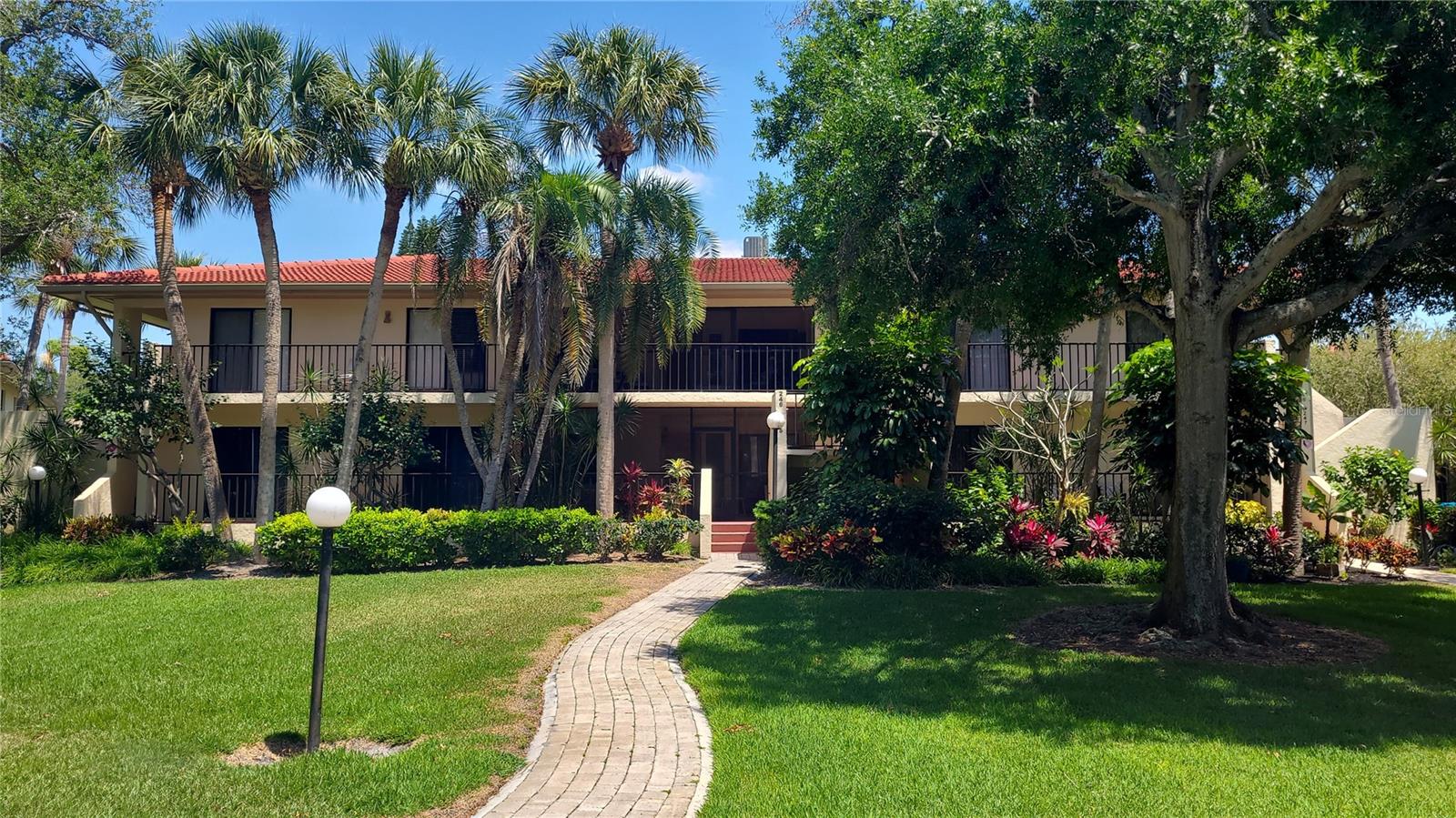 Experience effortless, living in this 2-bedroom, 2-bathroom main-floor condo—no stairs required! Step into your spacious, screen-enclosed front porch, perfect for morning coffee or evening unwinding. Inside, the open-concept living and dining area flows seamlessly toward the back lanai, where newly installed tile flooring makes upkeep a breeze. Relax as you overlook the community pool and lush, park-like grounds beyond. Your oversized primary suite is a true retreat, featuring an ensuite bathroom, a generous walk-in closet, and private access to the lanai. The second bedroom—ideal for guests, a home office, offers its own large walk-in closet plus an extra wall closet, with easy access to the adjacent guest bath. Enjoy peace of mind with recent updates: the tile roof was replaced just four years ago, the air-conditioning system was installed in 2022, and the water heater was updated in 2020. Plus, Terrace Two boasts the lowest condo fees in the community, so you can take advantage of all Wild Oak Bay offers without breaking the bank. Wild Oak Bay is a sought-after community renowned for its resort-style amenities pool, a spa hot tub, tree-lined streets, and impeccably maintained landscaping. You’re just minutes from IMG Academy, local shopping and dining, and the cultural attractions of Sarasota, with SRQ airport less than five miles away. Anna Maria beaches are 8.5 miles away. This condo blends tranquility with convenience—ready to welcome you home.