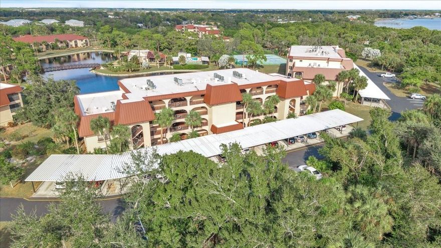 Welcome to Rolls Landing, a gated waterfront community offering Gulf-access boating to Charlotte Harbor and the Gulf of Mexico, with first-come, first-serve boat docks. Lush, garden-like landscaping and brick paver walkways create an inviting setting that immediately captures the essence of relaxed Florida living. This second-floor, two-bedroom, two-bath residence features peaceful lake views, convenient elevator access, an assigned covered parking space, and ample guest parking. The open living and dining area is filled with natural light and showcases picturesque views of the lake and charming walking bridge, enhanced by wood-look tile flooring that is both stylish and practical for everyday living and entertaining. Sliding glass doors open to a private 16x9 balcony, the perfect spot to enjoy morning coffee or unwind while taking in tranquil sunsets. The kitchen offers ample cabinet and counter space, a walk-in pantry, and a suite of appliances including a trash compactor, along with a breakfast bar that opens seamlessly to the main living area. A convenient in-unit washer and dryer add to the ease of living. The primary bedroom overlooks the lake and features a ceiling fan, walk-in closet, private access to the balcony, and an en-suite bath with an updated walk-in shower and extended dual sink vanity. A bright and spacious guest bedroom comfortably accommodates visiting family and friends and access to its own full bathroom. Condo fees include cable TV, water, and sewer, as well as access to an impressive array of resort-style amenities. Rolls Landing offers 24-hour on-site security, a clubhouse with a kitchen for entertaining, a fitness center, heated community pool and spa, tennis courts, shuffleboard, pickleball, bocce ball, ping pong, billiards, and a community library with workspace. Outdoor amenities include an inviting fire pit, two gas grills, car and boat washing stations, a community garden with a watering station, and scenic biking and walking trails. For boating and fishing enthusiasts, the community also provides kayak storage, boat trailer parking, dry boat storage, and boat slips, while the fishing pier extends several hundred feet and features 24 boat slips and a tiki hut—an ideal spot to enjoy breathtaking sunrises and sunsets over the water.  PLEASE ENJOY THE 3D INTERACTIVE VIRTUAL TOUR ASSOCIATED WITH THIS LISTING