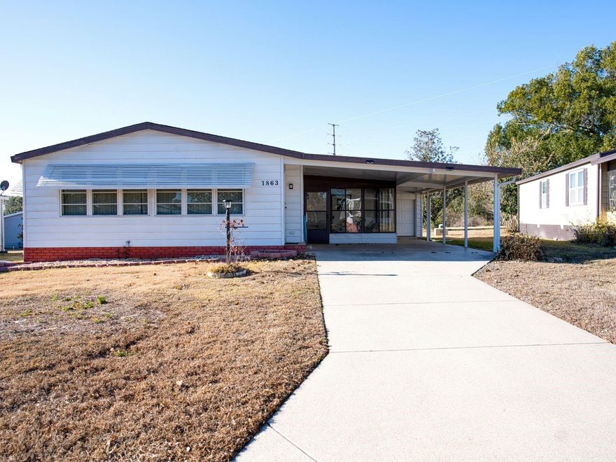 Short Sale. Welcome home to this unique single-wide manufactured residence located in the highly sought-after Village of Orange Blossom Gardens. Built in 1986, this 2-bedroom, 2-bath home offers 1,442 square feet of comfortable living space on an oversized 5,347 sq ft lot, larger than most in the area.

Step inside to a warm and inviting living room that flows into the kitchen and dining area, with an additional bonus room perfect for an office, hobby space, or Florida room. The spacious primary bedroom features a large walk-in closet and private bath. Carport parking adds everyday convenience.

Enjoy Florida living at its best with a generous backyard offering space for flowers, an herb garden, or additional landscaping, plus a peaceful water view to relax and unwind. Nestled in one of the most serene and established neighborhoods in The Villages, this home is close to golf, shopping, dining, and community amenities.

Don’t miss this chance to own in one of Florida’s most beloved communities!