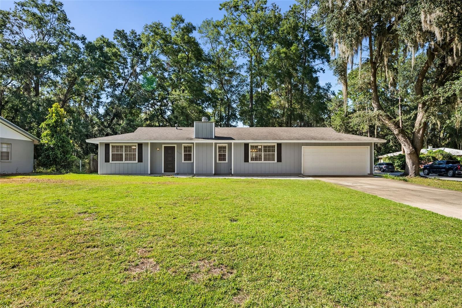 This 3 bedroom, 2 bath corner lot home has all the cozy charm you’ve been looking for, plus it is situated in a prime Gainesville location! The split floor plan gives everyone their own space, while the living area is cozy, inviting, and has a charming fireplace-perfect for the upcoming winter months. With no carpet throughout-just wood laminate and tile floors, cleaning is a breeze and the home feels fresh and easy to maintain. The kitchen is bright and airy with plenty of room to make it your own over time. Whether you keep it simple or dream up future updates, it’s a space with tons of potential to grow with you. Out back, a screened porch overlooks the fully fenced yard and is already set up for pets to play and your weekend barbeques. The 2-car garage adds extra storage and makes life that much easier. The seller has invested over $20,000 in professional tree removal, giving you a clean slate to enjoy the yard with peace of mind for years to come. You also don’t have to worry about big ticket expenses before moving in! The roof was replaced in 2019. This home is truly move-in ready and perfect for first-time buyers, growing families, or anyone looking for a comfortable, well-maintained space. Less than 5 minutes from Fresh Market, Uppercrust Bakery, Publix, and Thornebrook Shopping. Across the street from the Boys and Girls Club, around the corner from a top-rated high school (Buchholz), and just minutes from Santa Fe College. This is an amazing opportunity to own real estate in this neighborhood for this price. Call to set up an appointment today!