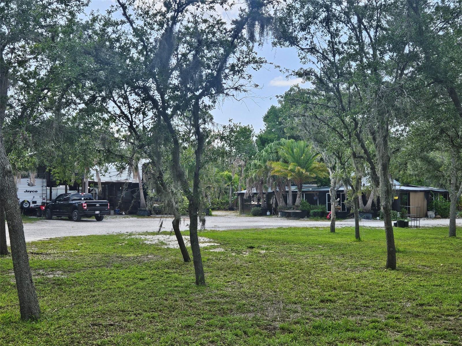 Bradenton's five acre private retreat. Over 300 manacured fruit and palm trees with 2 electrical boxes already on site, 3 RV Pads, 2 septic systems, well water system, the list of trees on site include Figs, mangos, avocados, Lemons, limes, keylimes, oranges, tangerines, pomelo, jackfruit, starfruit, persimmons, pomegranates, bananas, dragon fruit, loquat, papayas, peaches, plums, cherries, guava, blackberries, palm trees, limquat, and kumquat. This property is an oasis and is easy to access. 5 acres of pristine manacured cleared land with fruit trees, septic, and electic. See it and make it yours today!