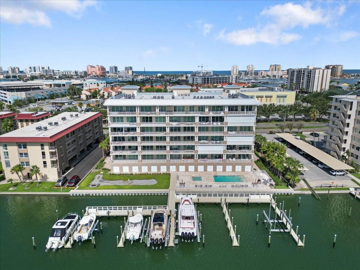 Check out the virtual tour link - Built in 2023 - Stunning 4th Floor waterfront residence - Never Lived in and only minutes from the sugar white sands of Clearwater Beach and overlooking the Intracoastal Waterway in Clearwater’s sought-after Island Estates community. This spacious 3-bedroom, 2-bath condo blends luxury, comfort, and convenience, all in one of Florida’s most vibrant coastal settings. Upon entry, a wide, welcoming hallway with striking water views sets a serene tone and leads you into a thoughtfully designed open layout. The heart of the home — the kitchen — features high-end cabinetry, GE Café appliances, and plenty of space for those who love to cook or entertain. The bright, airy living area is framed by a 3-pane sliding glass door that opens to stunning views of the Intracoastal Waterway, community pool, spa, and docks. Abundant natural light enhances the open feel, creating a perfect space for both relaxing and hosting. The primary bedroom is generously sized, complete with a walk-in closet and its own 3-pane sliding glass door leading out to a 30-foot balcony — an exceptional outdoor space equipped with ceiling fan outlets, electrical hookups, and a water spigot. The luxurious en-suite bath features a large walk-in shower, private water closet, dual sinks, and space for a makeup vanity. The second bedroom offers its own private en-suite bathroom, providing a comfortable and private retreat for guests or family members. A third spacious bedroom offers even more flexibility — ideal for a home office, visiting guests, or additional family members. Additional highlights include a large laundry room with storage, under cover & open garage parking with interior building access, two assigned spots and plenty of guest parking. Situated directly on the Intracoastal and just minutes from Clearwater Beach’s top attractions — including Pier 60’s nightly sunset celebrations, the Clearwater Marine Aquarium, beachside dining, shopping, boat tours, and watersports — this location offers a true resort-style lifestyle. And with the grocery store conveniently located just across the street, daily living is as easy as the sea breeze. Unit 403 at 125 Island Way is a rare opportunity to enjoy spacious, updated waterfront living in one of Clearwater’s most desirable communities. Come experience Island Estates — and make this exceptional condo your next home. Private Boat Slip available through separate negotiation. Available for immediate closing.