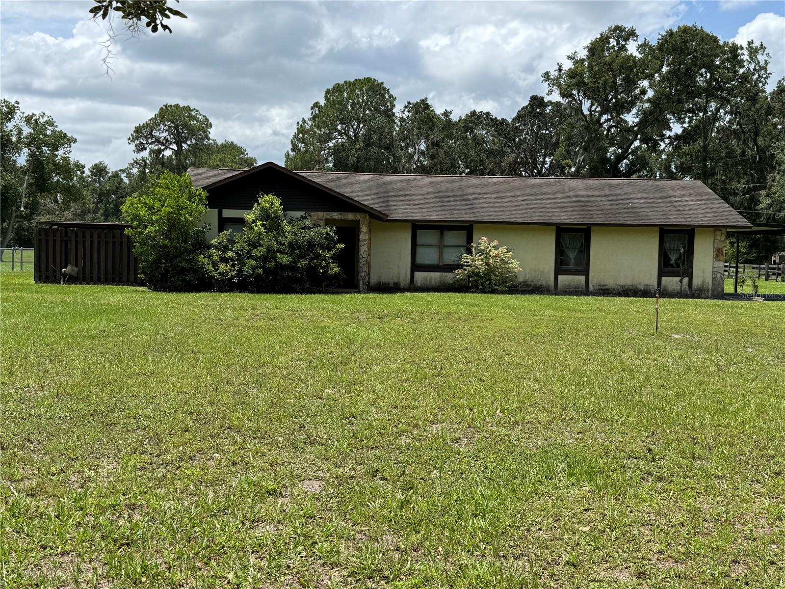 CUSTOM BUILT BLOCK 2/2 HOME ON 1.56 ACRES. BREAKFAST BAR & SOLID WOOD CABINETS IN KITCHEN, FAMILY ROOM HAS FIREPLACE. DOUBLE DOORS FROM DININGROOM TO FAMILY ROOM. IRRIGATION SYSTEM, GRANDFATHER OAKS, 2 CAR CARPORT, 56x36 METAL/WOOD BARN, STORAGE SHED & 16x16 WOOD DECK SCREENED ROOM DETACHED FROM HOUSE. PROPERTY IS FENCED WITH GATE AT DRIVEWAY. LAUNDRY ROOM OFF GARAGE. CALL FOR YOUR PERSONAL TOUR TODAY & MAKE THIS YOUR HOME! LOCATED MINUTES FROM I-4 FOR EASY ACCESS TO TAMPA OR ORLANDO