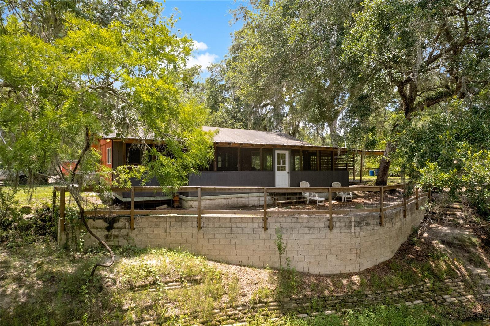 Tucked away along the peaceful banks of the Withlacoochee River and cradled by the Croom section of Withlacoochee State Forest, this 2-bedroom, 2-bath riverfront cabin is a rare blend of rustic charm and unbeatable natural surroundings. Whether you're seeking a full-time escape, a seasonal retreat, or a weekend getaway, this unique & rare Fixer Upper property delivers serene living in one of Florida’s most scenic outdoor playgrounds.
Nature lovers, adventurers, and peace seekers will appreciate the incredible privacy—bordered on three sides by pristine forest and riverfront, with only nature as your neighbor. While the home experienced approximately four inches of water intrusion during last summer’s rare storm event, it remains the only known occurrence of flooding in the property's history.
Inside, you'll find a light-filled open floor plan with warm wood details, an open kitchen, and peaceful views that bring the outdoors in. Both bedrooms are comfortably sized, and each bathroom offers convenience for you and your guests.
Step outside to enjoy the natural beauty from your screened porch or elevated riverside deck, perfect for morning coffee, evening sunsets, or watching wildlife. With direct river access, this is a haven for kayaking, fishing, paddleboarding, or simply floating your cares away.
Highlights Include: Adjacent to State Forest – hike, bike, or ride for miles, Surrounded by towering trees and native wildlife, Ample parking for RVs, boats, and outdoor gear, Only rear neighbors—just endless forest, Ideal for outdoor enthusiasts and those seeking solitude
A rare opportunity to own a cabin retreat that feels miles away—yet is conveniently located near I-75, Dade City, Brooksville, Webster, and Bushnell. Escape the everyday and reconnect with nature!