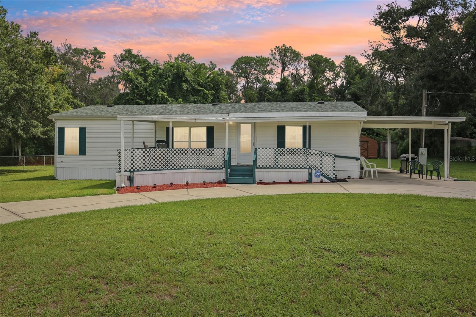 GORGEOUS PROPERTY ! GREAT LOCATION ! NO HOA OR CDD ! NO BACKYARD NEIGHBORS ! FENCED-IN YARD ! VERY PRIVATE SETTING WITH PART OF PROPERTY SITTING ON CONSERVATION AREA ! BRING YOUR RV/BOAT/TRUCK/TRAILERS/PETS AND CHICKENS ! Come See This Beautiful Mobile Home With 3 Bedrooms 2 Bathrooms That Has “Just Over” 1,100+ Square Feet Of Living Area Plus LARGE COVERED CARPORT AND FLORIDA ROOM In Back Of Home ! This Home And Property HAS SOME AMAZING FEATURES: Newer Roof (2022) HVAC (Approx. 8 Years Old) Hot Water Heater (Approx. 5 Years Old) LARGE CIRCULAR DRIVEWAY Front Yard, Nice Size Shed For Additional Storage And Covered Front Porch ! You Can Sit In Your VERY PRIVATE FLORIDA ROOM And Enjoy Relaxing With A Favorite Beverage Or Book ! The Back Yard Offers The Best Of Nature And LIVING THE FLORIDA LIFESTYLE As You Can Entertain Guests/Family/Friends ! There Is Plenty Of Room On This Property To Add A Detached Garage, A Private Pool Or Store Your Vehicles And Adult Recreational Toys ! This Home Has Public Water With Septic Tank So Your Utility Costs Will Be Less ! THIS HOME AND PROPERTY IS A MUST SEE ! Please Call Your Agent Today To Schedule Your Private Showing !