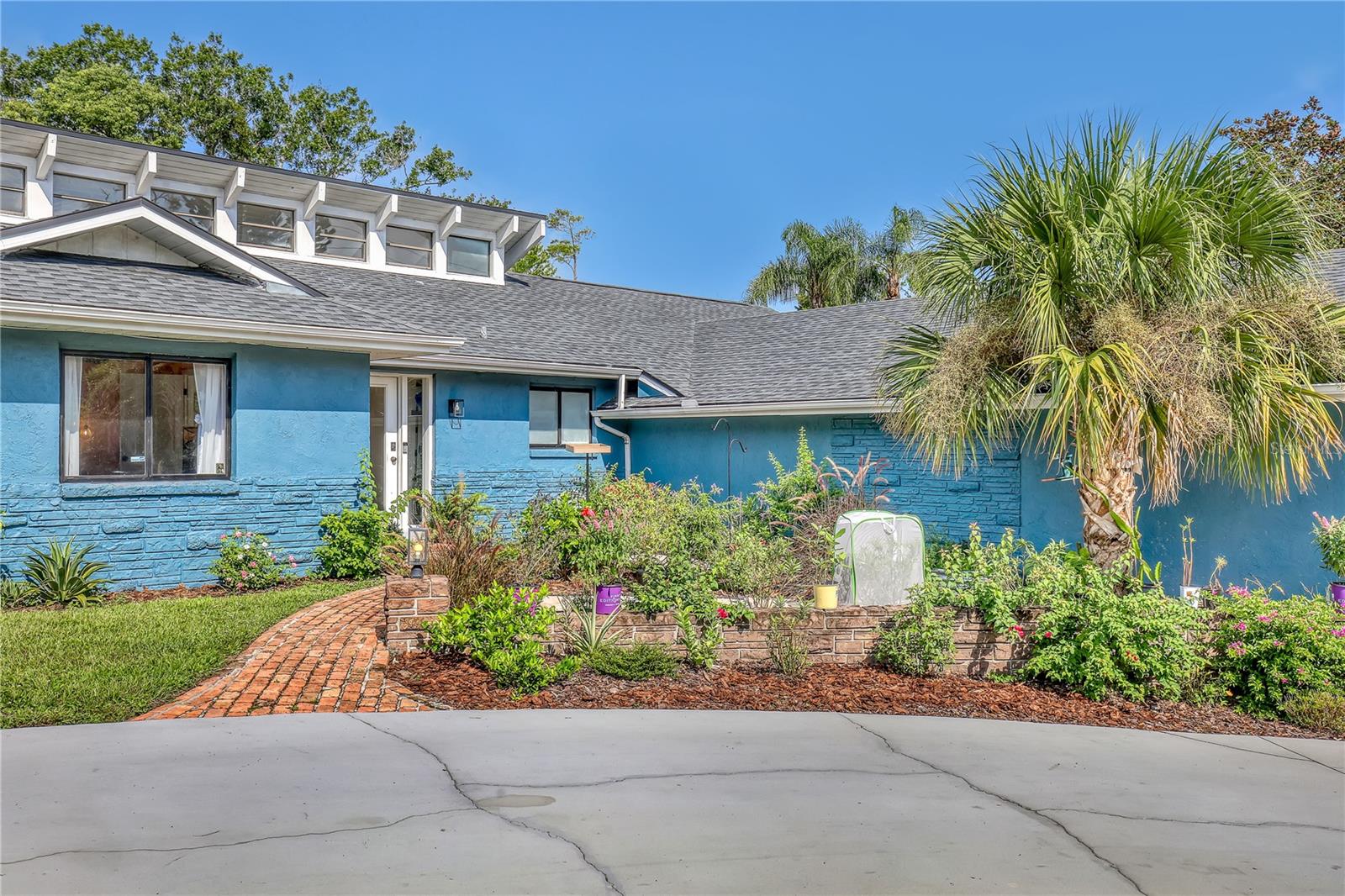 Watch live rocket launches from NASA Kennedy Space Center, relax on the beautiful beaches nearby, and explore historic Titusville! Welcome to this gorgeous, fully renovated MCM-style home featuring a newer roof (2022) and soaring vaulted ceilings, exposed wooden beams, and walls of windows that flood the space with natural light. The open floor plan offers 3 bedrooms plus a bonus room, two dining areas and a chef's kitchen with a large island, quartz waterfall countertops, modern marble backsplash, and elegant gold accents. Step outside to your private oasis: a completely refinished Saltwater pool with a tranquil waterfall feature, surrounded by a covered sitting area—perfect for entertaining or relaxing. 3-car garage with high ceilings and a spacious concrete patio—ideal for working on vehicles or extra parking 3 driveways for easy access and ample guest parking
Balcony off the owner's suite with private views
Newer kitchen, appliances, flooring, paint, and bathrooms. High-end finishes throughout and more!