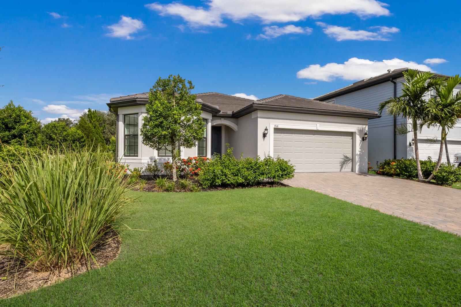 A beautifully upgraded, move-in ready home is nestled in the desirable gated enclave of Magnolia Ranch, just minutes from Lakewood Ranch and easy access south to Sarasota and north through Parrish to St Pete/Tampa. This home will rival any new construction in the area. Meticulously maintained, offering many thoughtful upgrades, including an extended screened paver lanai with a disappearing corner and custom motorized window treatments and three-car tandem garage with epoxy floors. Step inside to find a modern and airy interior featuring light cabinetry, quartz countertops, tile backsplash, stainless steel appliances, and 42" upper cabinets in the kitchen—perfectly designed for both casual dining and entertaining. The large center island provides ample prep space and additional seating, while the adjacent eat-in dining area invites cozy meals with family and friends. Modern tile throughout the main living area, upgraded lighting fixtures, ceiling fans, and window blinds. The recessed walk-in shower and frameless glass door in the primary bath offer a spa-like experience, while the home’s smart features—including a Ring doorbell and programmable lighting—add security and convenience. The floor plan is smart and no wasted space, with an oversized laundry room complete with sink and cabinetry. Tucked beyond the laundry room right outside the garage entry is extra space perfect for a drop zone for bags and shoes. Magnolia Ranch is a low-maintenance, NO CDD community with low HOA fees, and is perfectly positioned for year-round residents, snowbirds, or investors. Enjoy close proximity to world-class beaches, golf, dining, shopping, nature preserves, and vibrant downtown areas.