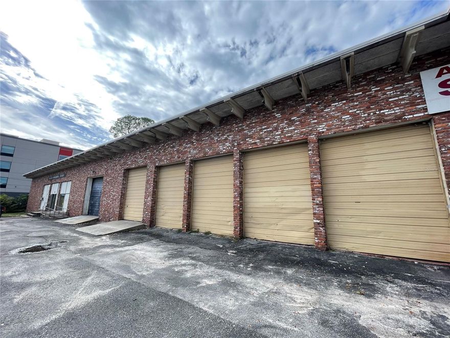 Warehouse with high ceilings and multiple load bays located just off 441/Pine Ave. Building has a demising wall with approximately a 60/40 split.  There is office along with warehouse space on the east side. The massive wide-open interior could be a great use for storage. Seller has never had power turned on to the building, only used for storage.  This is a cash only transaction.