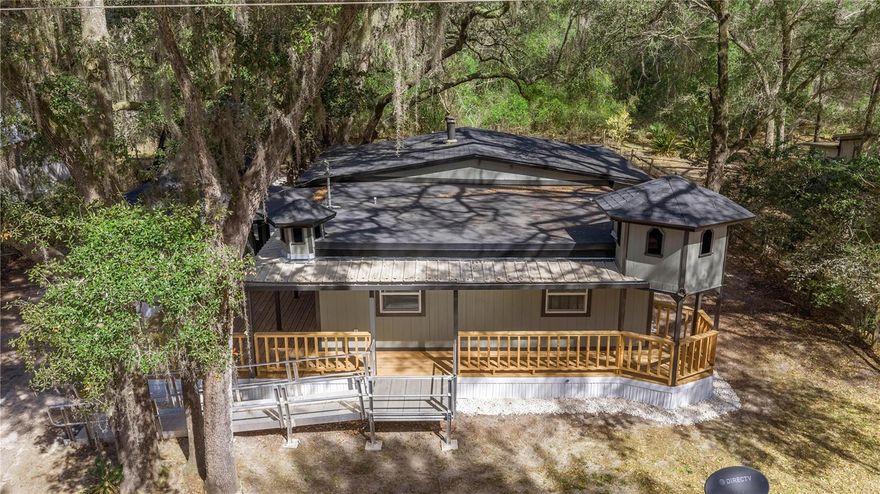 Stunningly renovated 3-bedroom, 2-bathroom single-family home offers turnkey perfection on a quiet, county-maintained dirt road – ideal for those seeking tranquility near the Ocala National Forest, Silver Springs State Park, and endless outdoor adventures. No HOA, no neighbors crowding you – just peaceful country vibes with every modern upgrade you need.
Inside, everything is brand new and beautiful:

Sleek stainless steel appliances shining in the open, welcoming kitchen
Custom wood cabinets for timeless style and plenty of storage
Fresh new flooring throughout – clean, durable, and gorgeous
New HVAC system keeping you comfortable year-round
Brand-new roof for worry-free ownership ahead

The thoughtful layout provides three cozy bedrooms and two full baths. Step outside to your private oasis:

Expansive huge back deck – ready for grilling, relaxing, or watching sunsets
Large front deck fully enclosed with screening to enjoy Florida breezes without the bugs
Standout large detached garage built like a charming barn – ideal for vehicles, tools, hobbies, workshop, or extra storage

This home has been completely refreshed from top to bottom, blending rustic charm with contemporary convenience. 
Why This is a Must-See Value:

Fully renovated with new roof, HVAC, flooring, stainless appliances & wood cabinets
3 bedrooms / 2 bathrooms in ~1,468 sq ft
Massive screened front deck + huge back deck for outdoor living
Barn-style detached garage adds incredible versatility
Serene rural setting on county-maintained dirt road – close to nature, springs, trails & recreation
Move-in ready – no work needed, just unpack and enjoy!

Opportunities like this don't last – a renovated country charmer with premium features at this price point is rare!