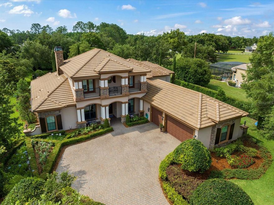 Discover unparalleled elegance in this luxurious custom-built home nestled on over an acre of beautifully landscaped grounds within the prestigious gated community of Northbridge at Lake Pretty! Designed with refined details and superior craftmanship, this home is the epitome of sophistication. As you approach via the elongated pavered driveway, you are greeted by a dual-entry 12’ mahogany front door entry that opens into a grand foyer with engineered hardwood floors and soaring ceilings, the formal dining area offers faux painted columns, crown molding, stenciled  tray ceiling and a stunning chandelier, wonderous formal living area with custom coffered, crowned ceilings, wood fireplace, recess lighting, and triple 10’ sliders , chef’s kitchen is a culinary dream equipped with new quartz countertops, center island  and breakfast bar (2024), refreshed cabinetry, wood beam decorative ceilings, top of the line stainless steel GE Monogram appliances including double ovens and induction cooktop, custom hood vent with tiled backsplash under the hood vent while the rest of the backsplash is quartz, goose neck faucet, farmer’s sink, crown molding, soft close drawers and cabinet organizers, oversized walk in pantry includes cabinets and built in shelving while the eat-in area features picturesque mitered windows,  the family room boasts plantation shutters, hardwood floors, wood beam accents and recess lighting with French doors leading to the covered lanai with tongue and groove ceilings and travertine pavers overlooking the outdoor oasis which includes a salt water pool and raised spa, extra sundeck ,outdoor kitchen with yet another wood burning fireplace and an additional decorative fireplace and water fountain all overlooking the stunning manicured lawn, the freshly painted downstairs master bedroom offers double tray ceilings, hardwood floors, recess and chandelier lighting, sitting area, plantation shutters, walk in closet with closet organizers and private French door exit to  the lanai, , dynamic master bath with wood encased mirrors, dual sinks, Carrera marble countertops, make up vanity, garden jacuzzi tub and an immense walk in shower, study with dual entry with hardwood floors, chair railings and crowned molding, additional 3 vast guest rooms are conveniently placed on the lower level an offer walk in closets, hardwood floors, plantation shutters and crown molding with 2 additional bedrooms upstairs along with an upstairs bonus room/play area with built in desks, coffered ceilings and built in shelving, gym room/extra bonus features plush carpet ,tray ceilings and designer paint,
oversized laundry room with custom cabinetry and utility sink, 14’ ceilings in the first level, 10’ ceilings on second levels, newer Trane AC units (all 4 in 2020), 1000 gallon hot water heater (2020), 1000 LB propane tank, whole house generator and more! Experience the ultimate in luxury living where every detail is designed for comfort, style and convenience.