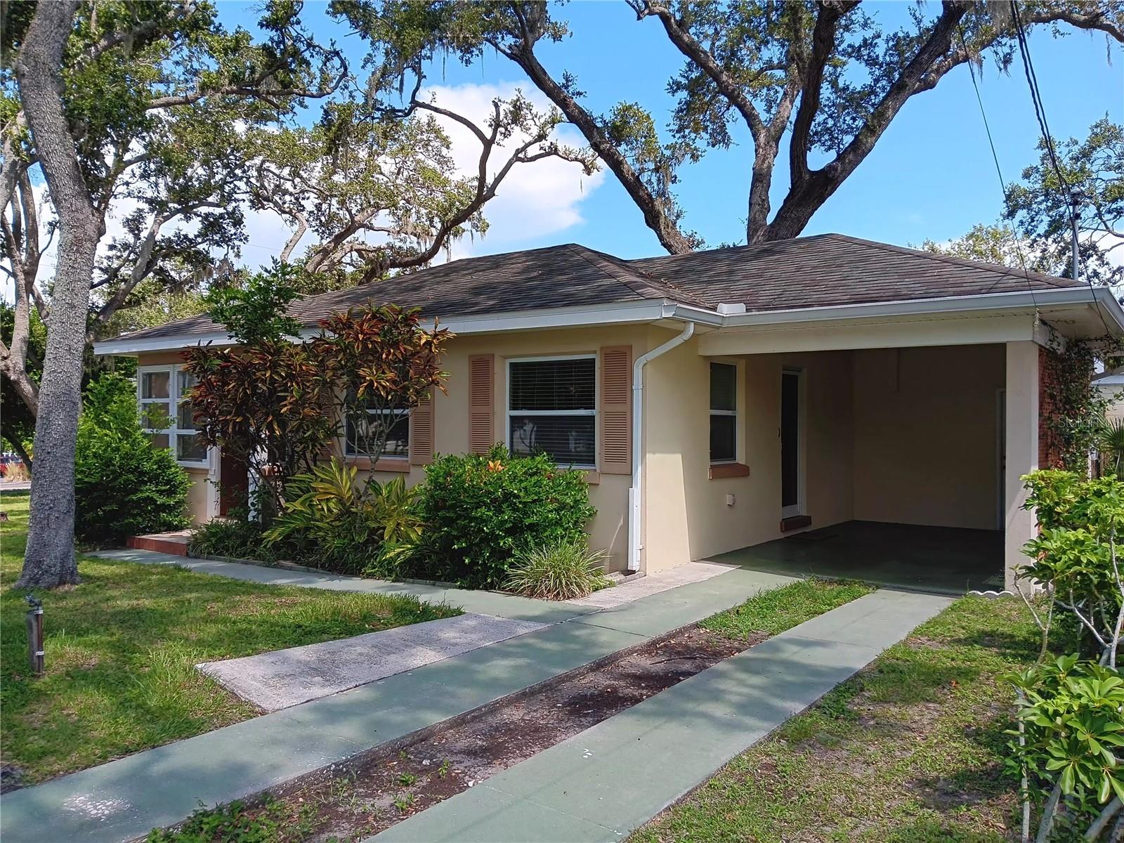 Under contract-accepting backup offers. Beautiful home situated on a large corner parcel 100 x 60 among mature trees and lush landscaping. This is a well-cared for 2 Bed 1 Bath with carport and attached air-conditioned workshop/laundry. Nicely placed 8'x12' storage shed located on the property. Conveniently located close to public transportation, only 2 miles from the Clearwater beaches. Great rental possibilities or a nice starter home with room for expansion. P Furnished with all appliances. Newer central A/C unit and water heater, move in condition.